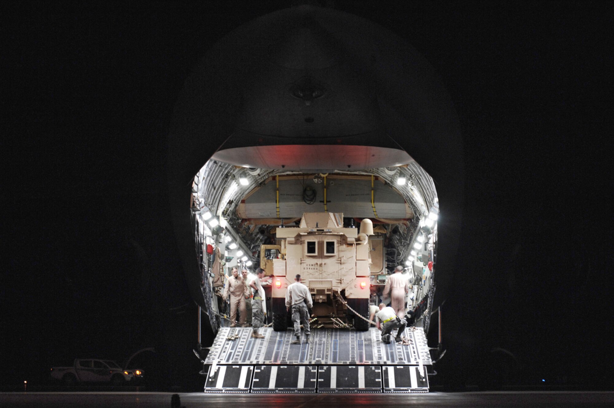 U.S. Air Force Airmen from the 386th Expeditionary Logistics Readiness Squadron’s aerial port flight secure Mine Resistant Ambush Protected vehicles to the flooring of a C-17 Globemaster III cargo bay Feb. 8 at a Persian Gulf air base. The MRAP vehicles are being delivered to the Marine Corps units throughout the area of responsibility in support of Operations Enduring and Iraqi Freedom. (U.S. Air Force photo/Staff Sgt. Patrick Dixon)