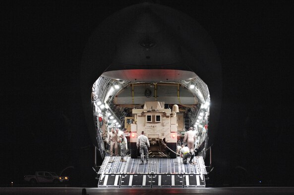 U.S. Air Force Airmen from the 386th Expeditionary Logistics Readiness Squadron’s aerial port flight secure Mine Resistant Ambush Protected vehicles to the flooring of a C-17 Globemaster III cargo bay Feb. 8 at a Persian Gulf air base. The MRAP vehicles are being delivered to the Marine Corps units throughout the area of responsibility in support of Operations Enduring and Iraqi Freedom. (U.S. Air Force photo/Staff Sgt. Patrick Dixon)