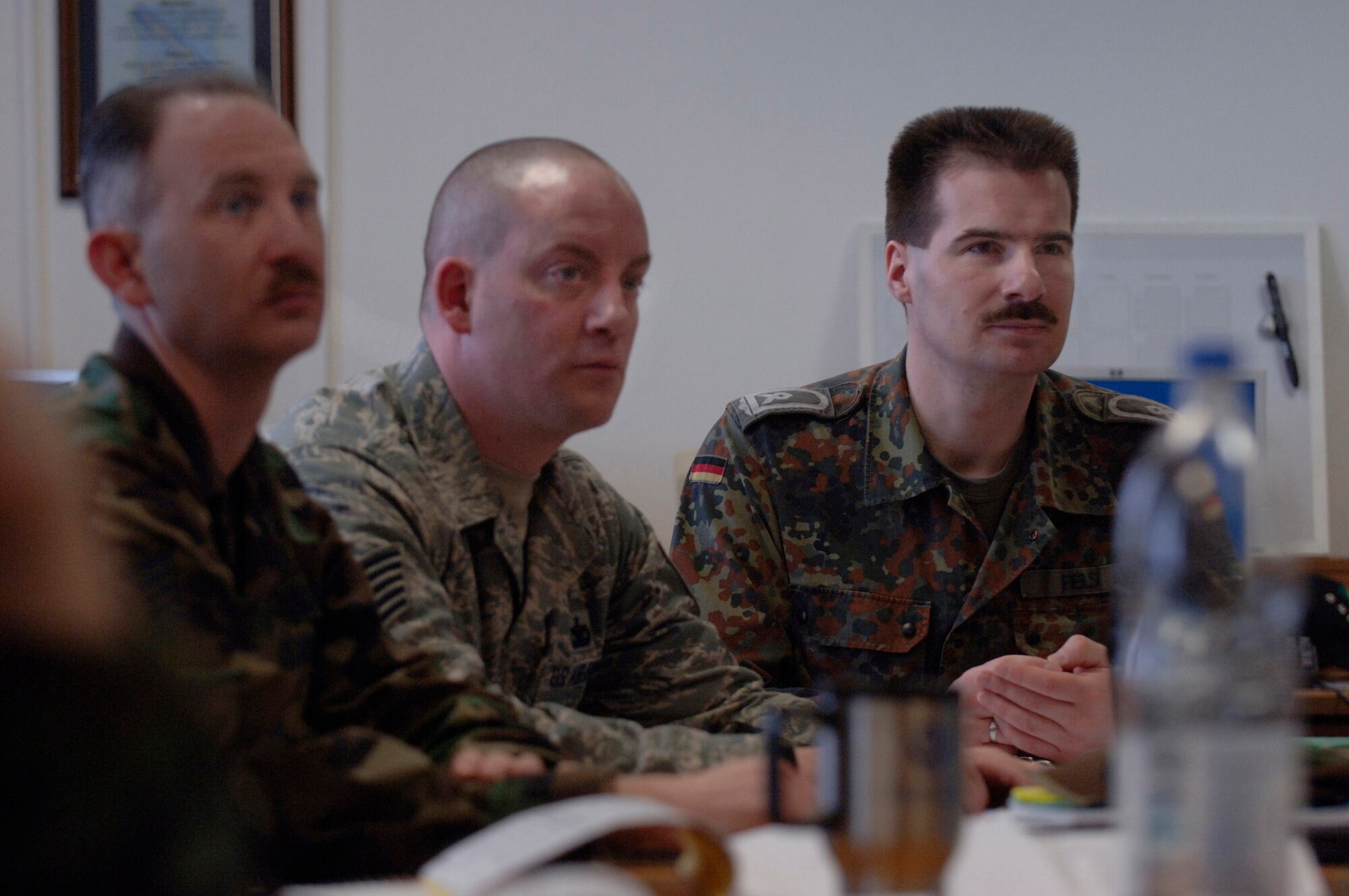 German air force Master Sgt. Holger Fels (right) and Tech. Sgt. Eric Corriveau (center) listen to a lecture about involving subordinates in the process of problem sovling March 26 at the Kisling Noncommissioned Officer Academy at Kapaun Air Station, Germany. Sergeant Fels, a German NCO academy instructor in Appen, Germany, voluntarily enrolled in the six-week course to prepare for his next assignment as an exchange instructor at the Senior NCO Academy at Maxwell Air Force Base, Ala. -- a four-year special duty assignment. (U.S. Air Force photo/Master Sgt. Scott Wagers)