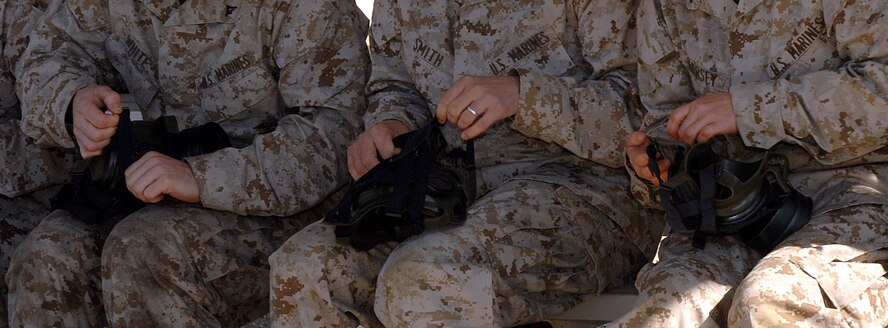 DYESS AIR FORCE BASE, Texas- Marines from Detachment 1, inspect their gas mask before entering the gas chamber, April 12. The gas masks are inspected to maintain seviceability. (U.S. Air Force photo by Senior Airman Courtney Richardson)