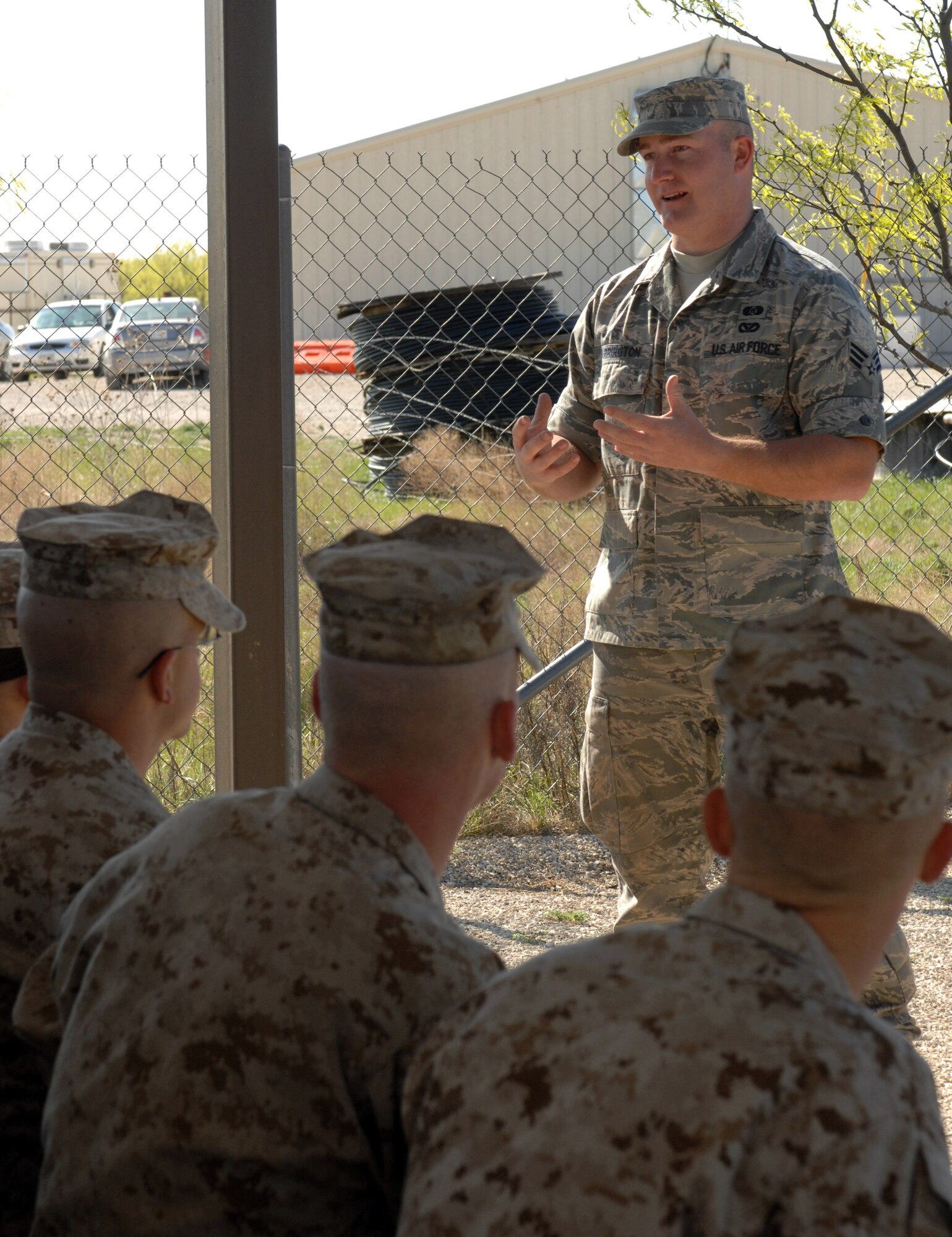 DYESS AIR FORCE BASE, Texas- Senior Airman Scott Arrington, emergency management, introduces himself to the Marine detachment before the beginning of chemical warfare training, April 12. Chemical warfare training consists of the proper wear of a chemical suit,gas mask, and gas mask confidence training. (U.S. Air Force photo by Senior Airman Courtney Richardson)