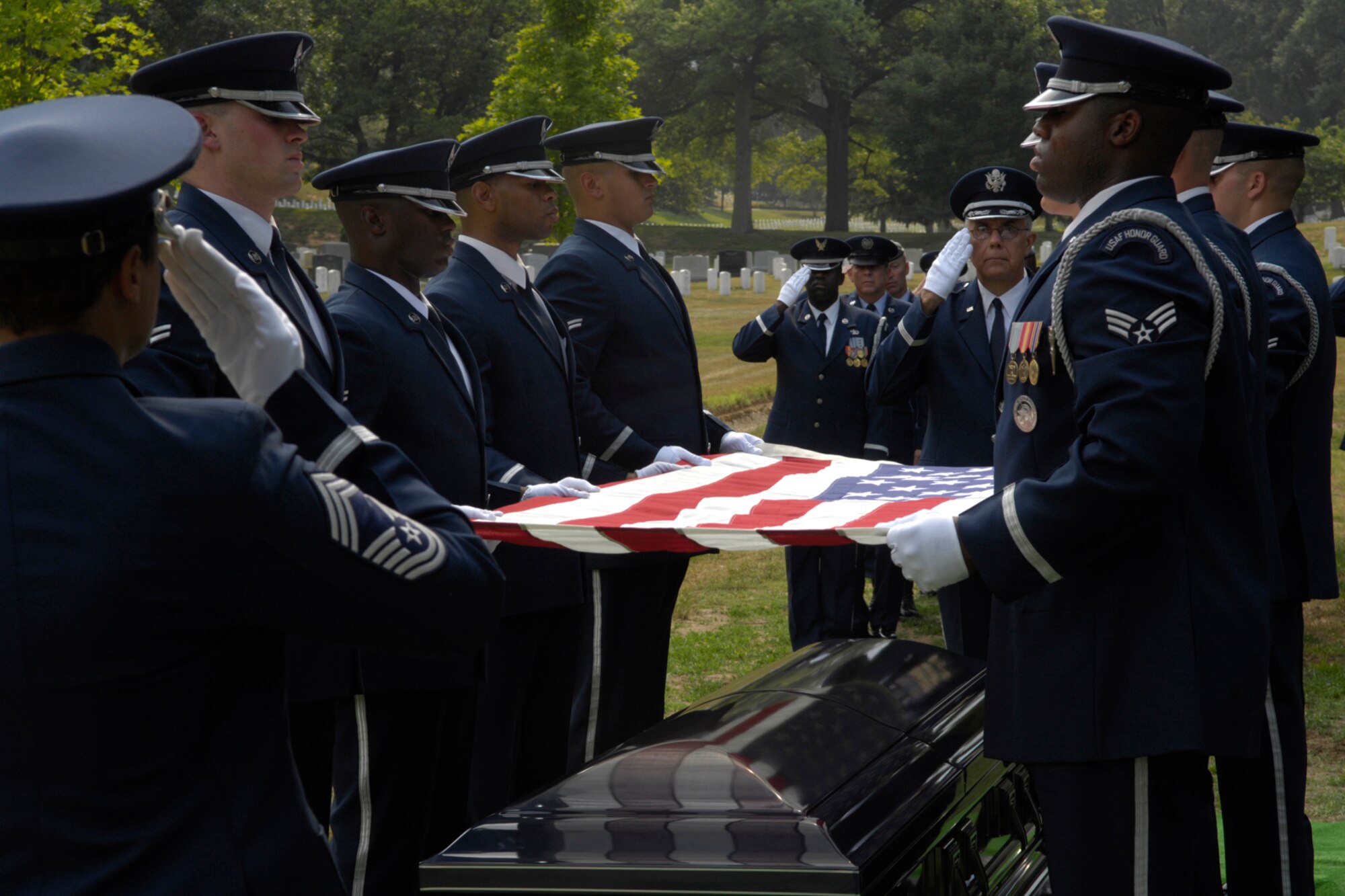 Chief Master Sgt. Robin Johnson, Air Force Honor Guard chief enlisted manager, salutes the flag to be folded and handed to the next of kin during the funeral for the 10th Chief Master Sgt. of the Air Force Gary Pfingston last July. (U.S. Air Force photo by Senior Airman Rusti Caraker)