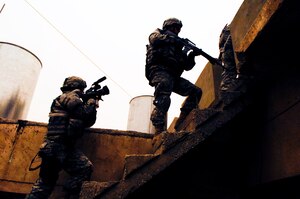 U.S. Air Force Senior Airman Michelle Emery documents a cordon and search conducted by U.S. Army Soldiers from Delta Company, 2nd Battalion, 22nd Infantry Regiment, 10th Mountain Division, and Iraqi's Emergency Service Unit, Amulshabi,  Kirkuk, Iraq. 
(U.S. Air Force Photo by Staff Sgt. Samuel Bendet)