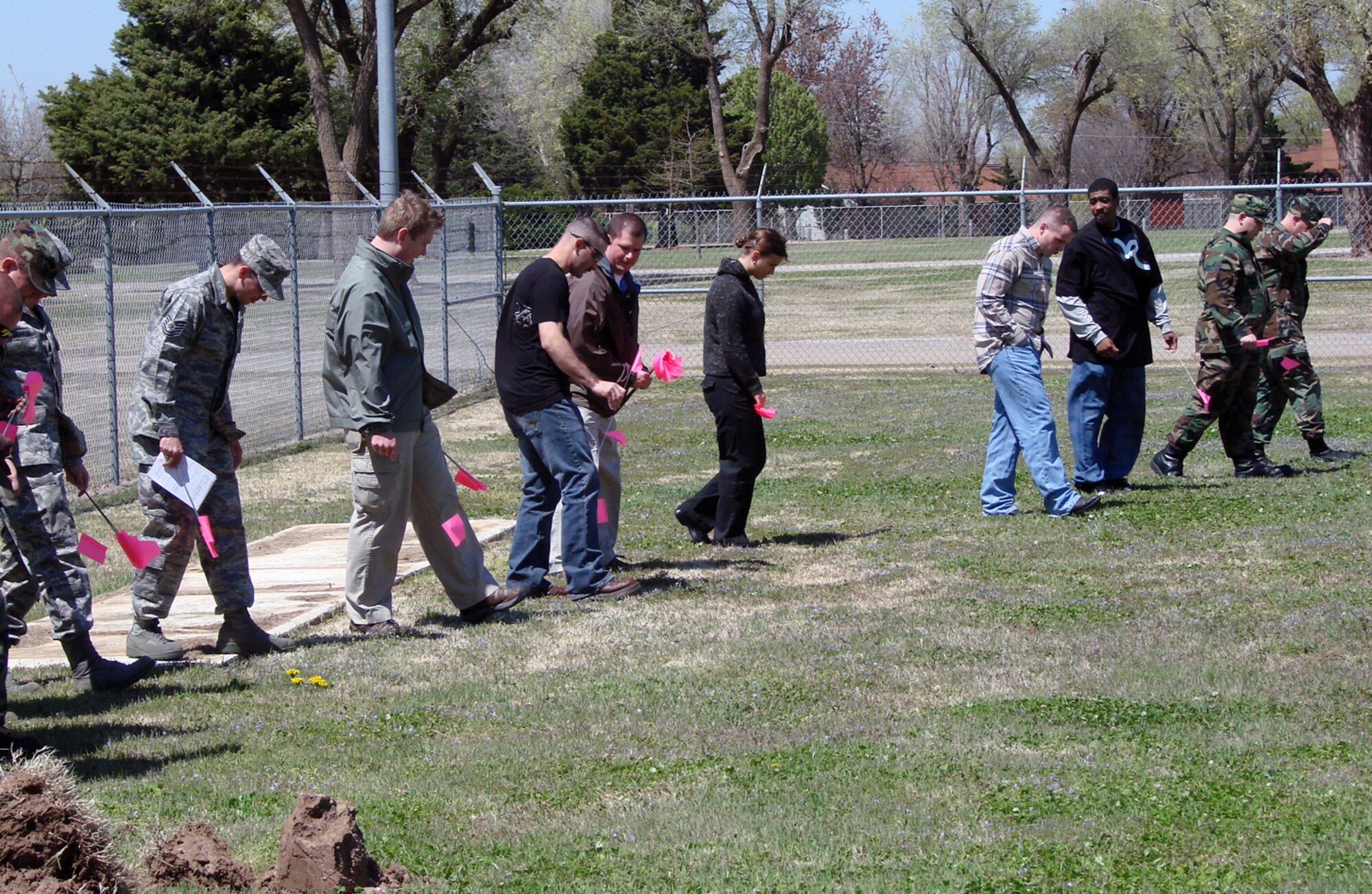 Vance bioenvironmental, AFOSI, security forces and fire department personnel walk a grid and mark evidence during an exercise Tuesday on how to preserve and process a chemical or weapon of mass destruction scene that may be a result of criminal activity. Team Vance first responders received the training on how to process a hazardous materials incident from an Air Force Office of Special Investigators crime scene investigator. (Air Force Photo by Capt. Tony Wickman)