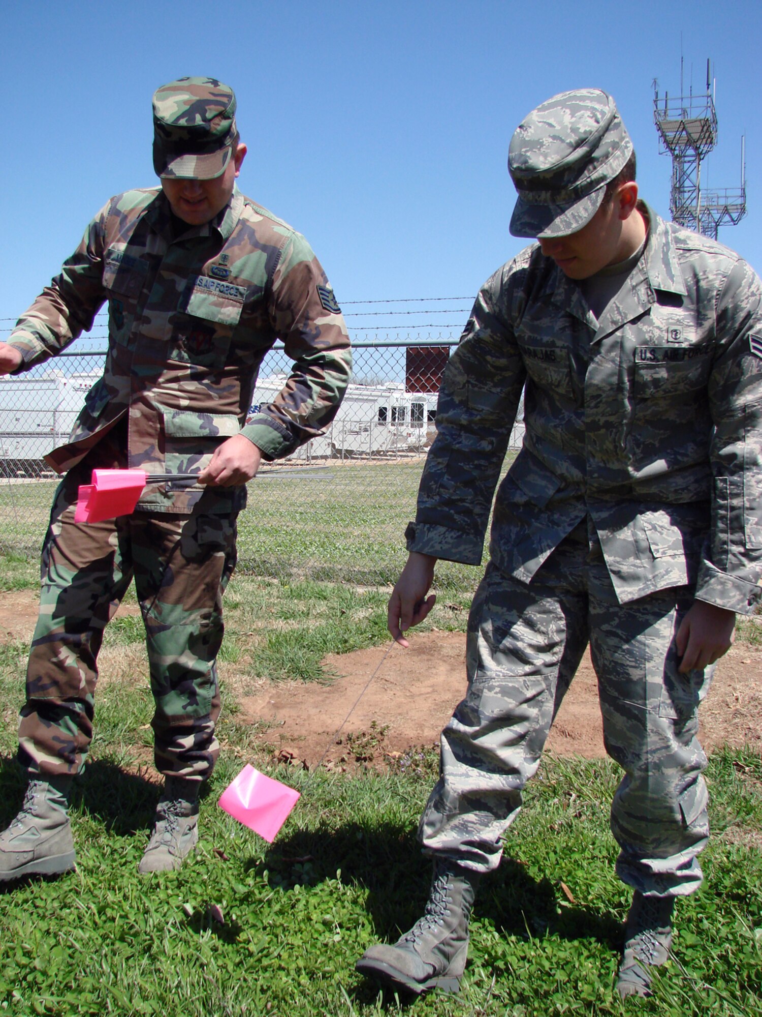 Staff Sgt. Andrew McGee and Airman 1st Class Justin Barajas, both with 71st Medical Group bioenvironmental engineering, mark evidence while walking a grid during an exercise Tuesday on how to preserve and process a chemical or weapon of mass destruction scene that may be a result of criminal activity. (Air Force Photo by Capt. Tony Wickman)
