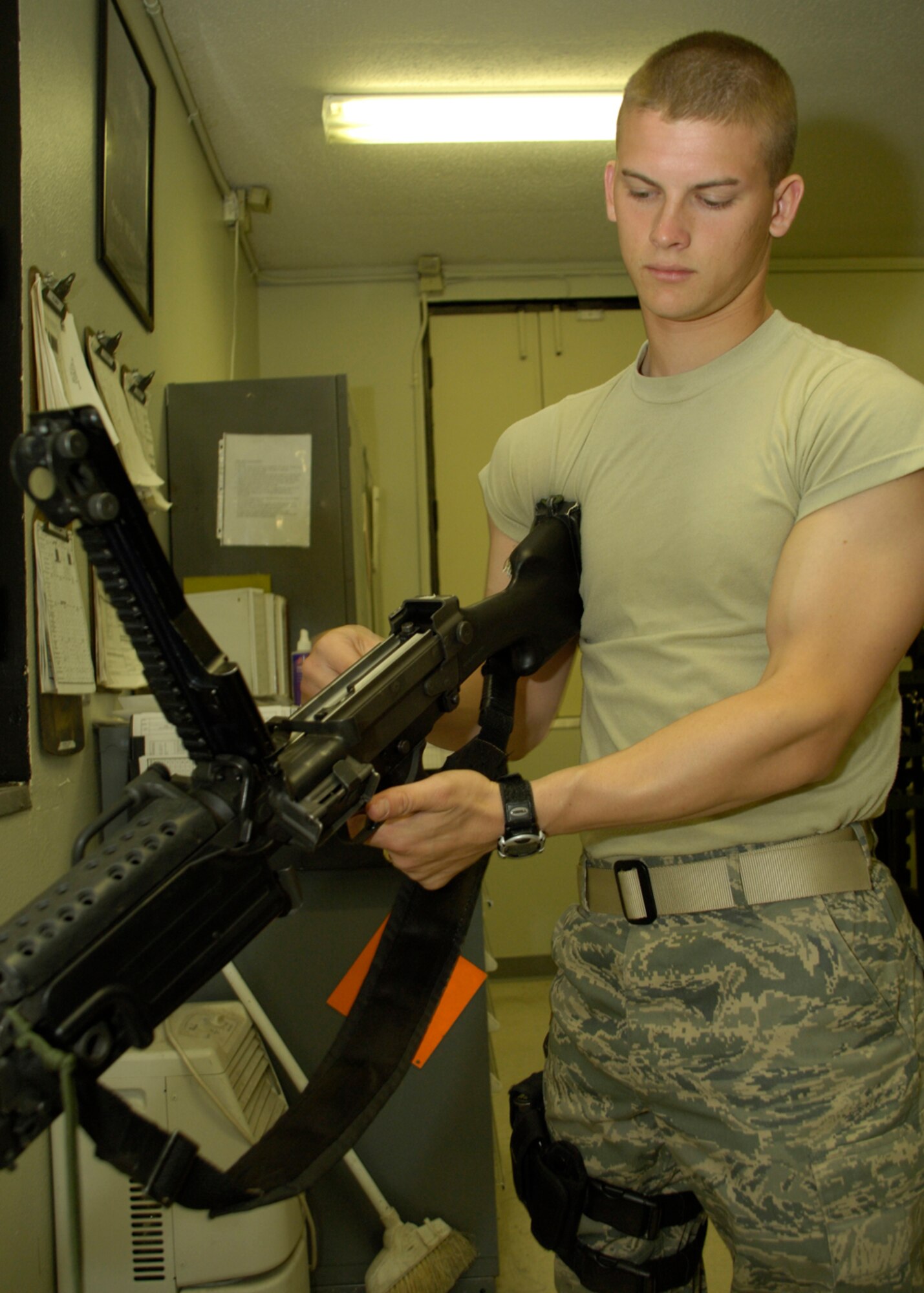 HOLLOMAN AIR FORCE BASE, N.M. -- Senior Airman Jeremy Grizzle, an armorer from the 49th Security Forces Squadron, clears and visually inspects a 5.56 mm M-249 squad automatic weapon at the armory here April 15. The 49 SFS provides force protection programs to include weapon system security, police services, resource protection and antiterrorism for the 49th Fighter Wing. They also maintain a wartime and contingency rapid deployment capability to conduct force protection operations worldwide. (U.S. Air Force photo/Airman 1st Class Michael J. Means) 