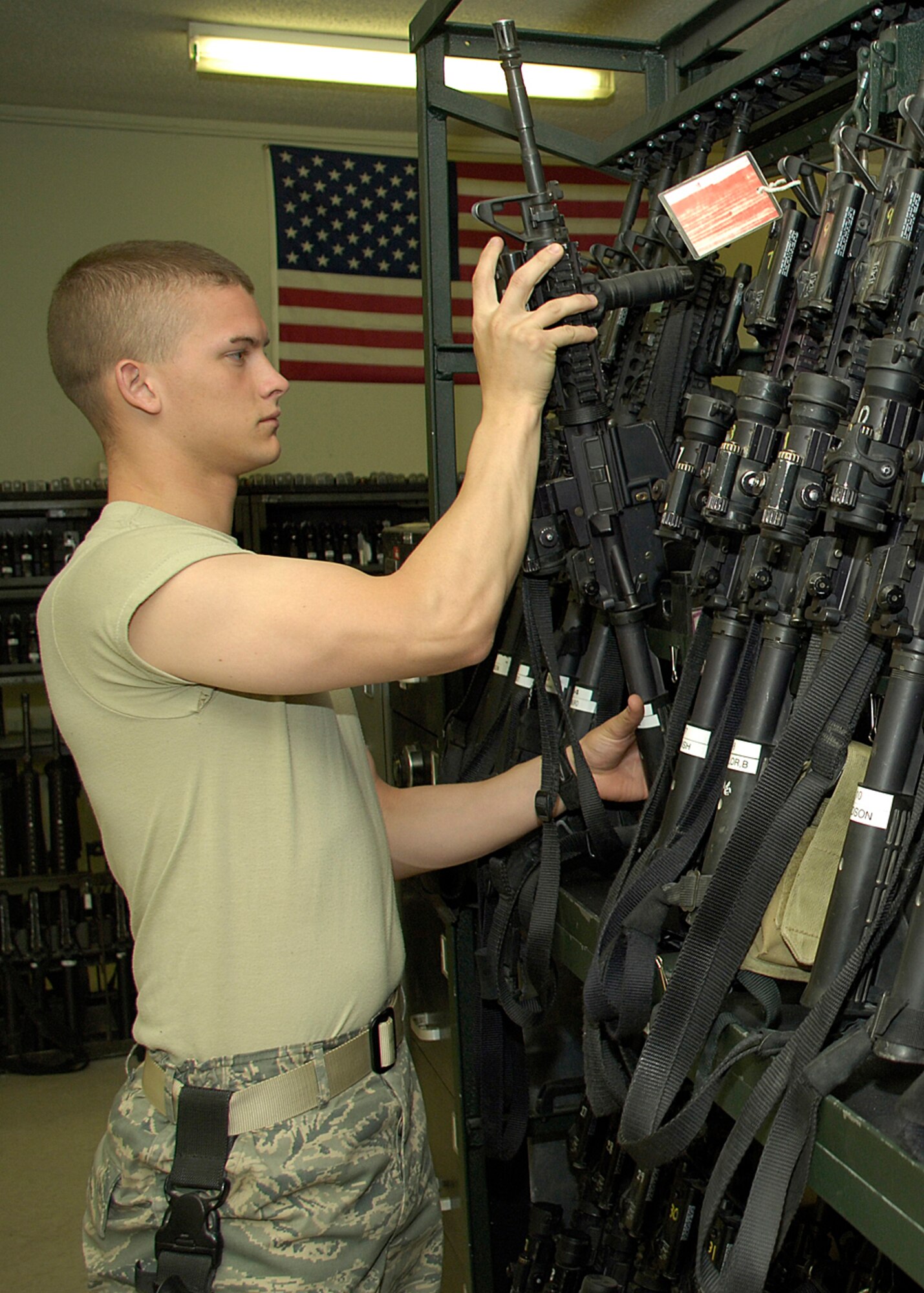 HOLLOMAN AIR FORCE BASE, N.M. -- Senior Airman Jeremy Grizzle,49th Security Forces Squadron, retrieves a 5.56 mm M-4 carbine rifle from the armory shelf for issue to a security forces member taking post for the day. The 49 SFS maintains a wartime and contingency rapid deployment capability to conduct force protection operations worldwide. 