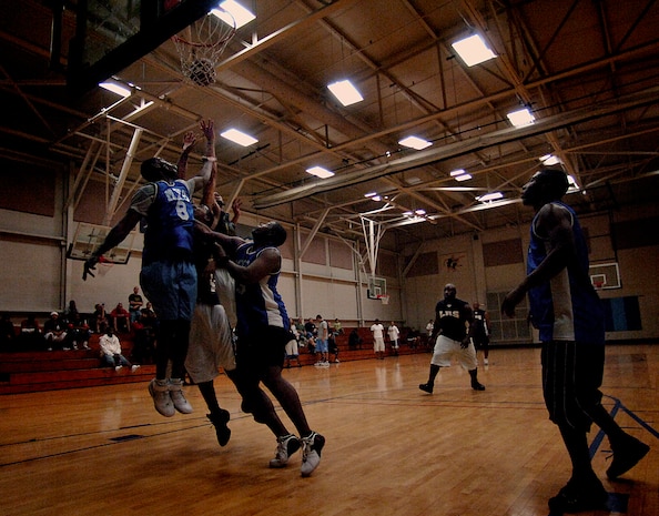 Airmen from the 437 LRS and 437 MXS jump for a rebound at the Charleston AFB Fitness and Sports Center Tuesday. (U.S. Air Force photo/Senior Airman Nicholas Pilch)