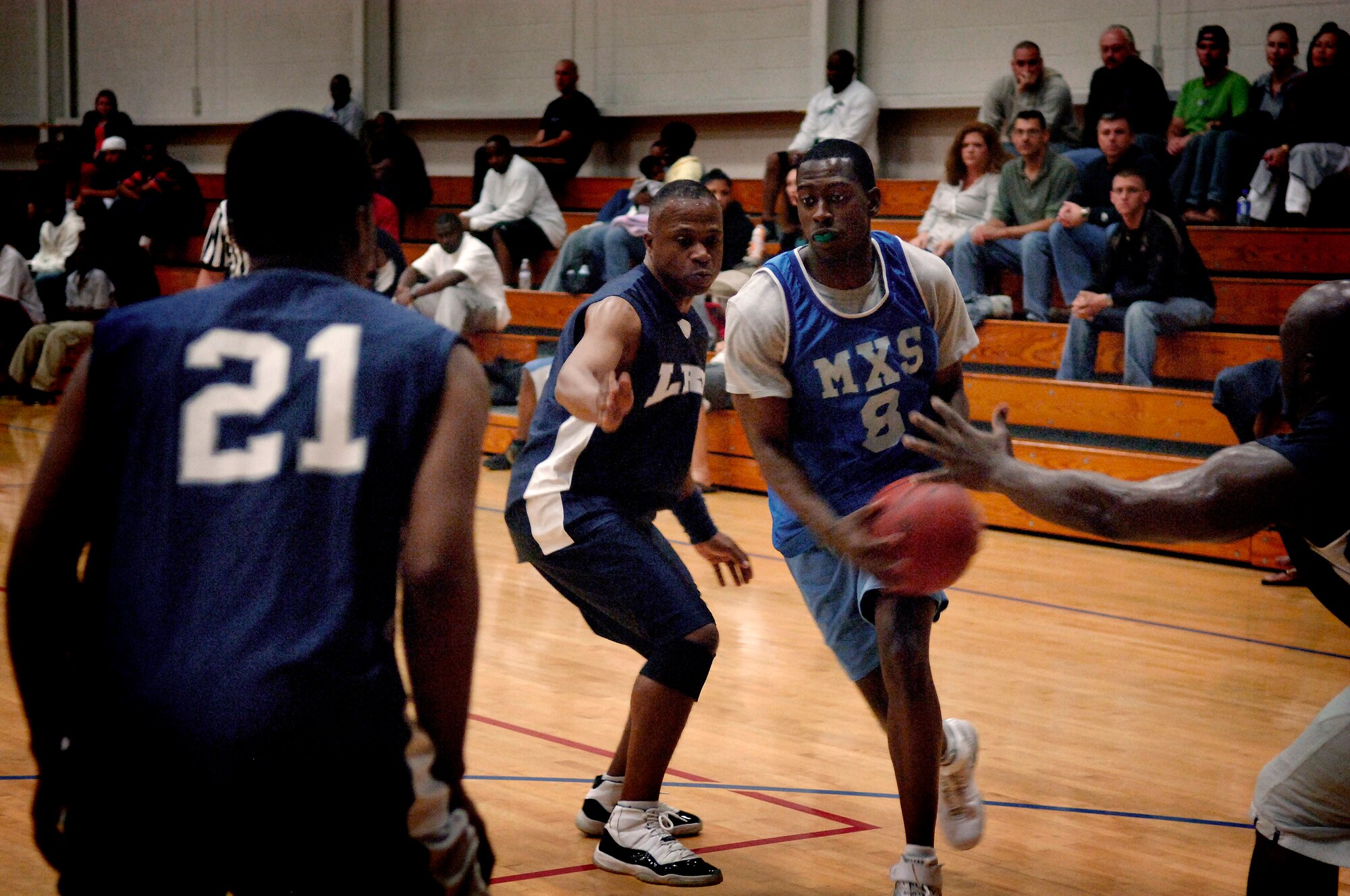 Kenneth Travis attempts to dribble through the 437 LRS defense at the Charleston AFB Fitness and Sports Center Tuesday. Travis plays for the 437 MXS. (U.S. Air Force photo/Senior Airman Nicholas Pilch)