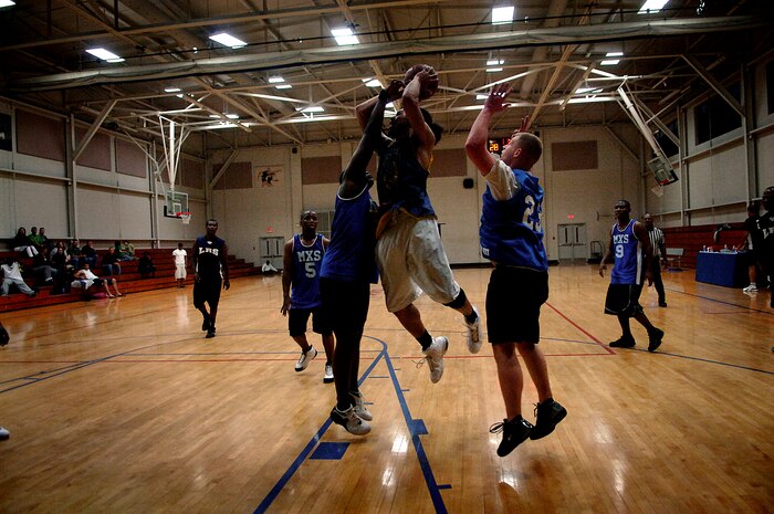 Shawn Clinton takes a jump shot over a 437th Maintenance Squadron defender during an intramural basketball play-off game at the Charleston AFB Fitness and Sports Center Tuesday. The 437th Logistics Readiness Squadron beat the 437 MXS 45 to 39 in a close game. Clinton plays for the 437 LRS. (U.S. Air Force photo/Senior Airman Nicholas Pilch)