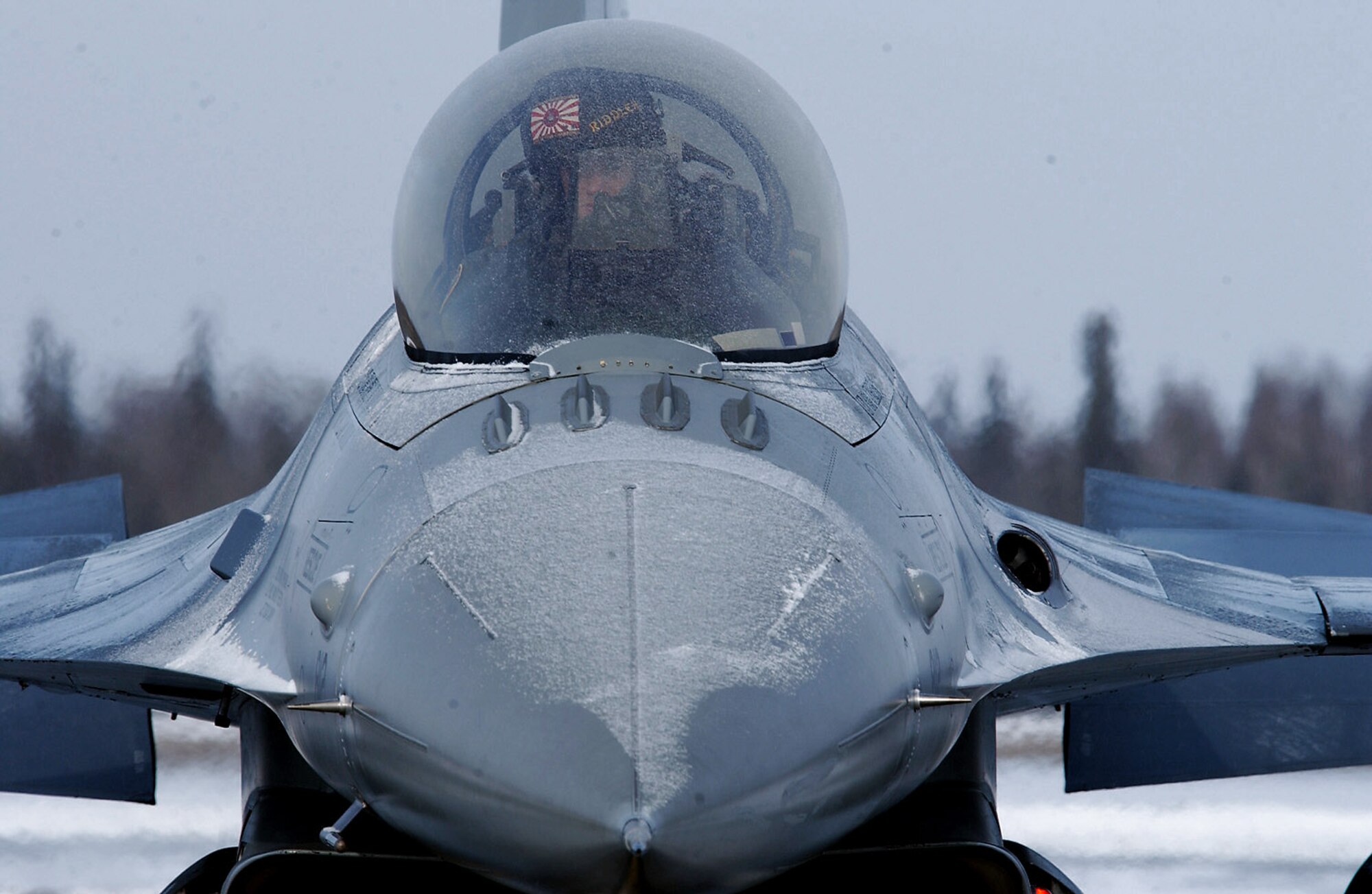 Capt. Bryan Spence controls the flaps and rudder on an F-16 Fighting Falcon during a preflight inspection to ensure all ice build up has been melted for maximum aerodynamic performance before a Red Flag-Alaska 08-2 training mission April 8 at Eielson Air Force Base, Alaska. Captain Spence is assigned to Misawa Air Base, Japan. (U.S. Air Force photo/Airman 1st Class Jonathan Snyder) 
