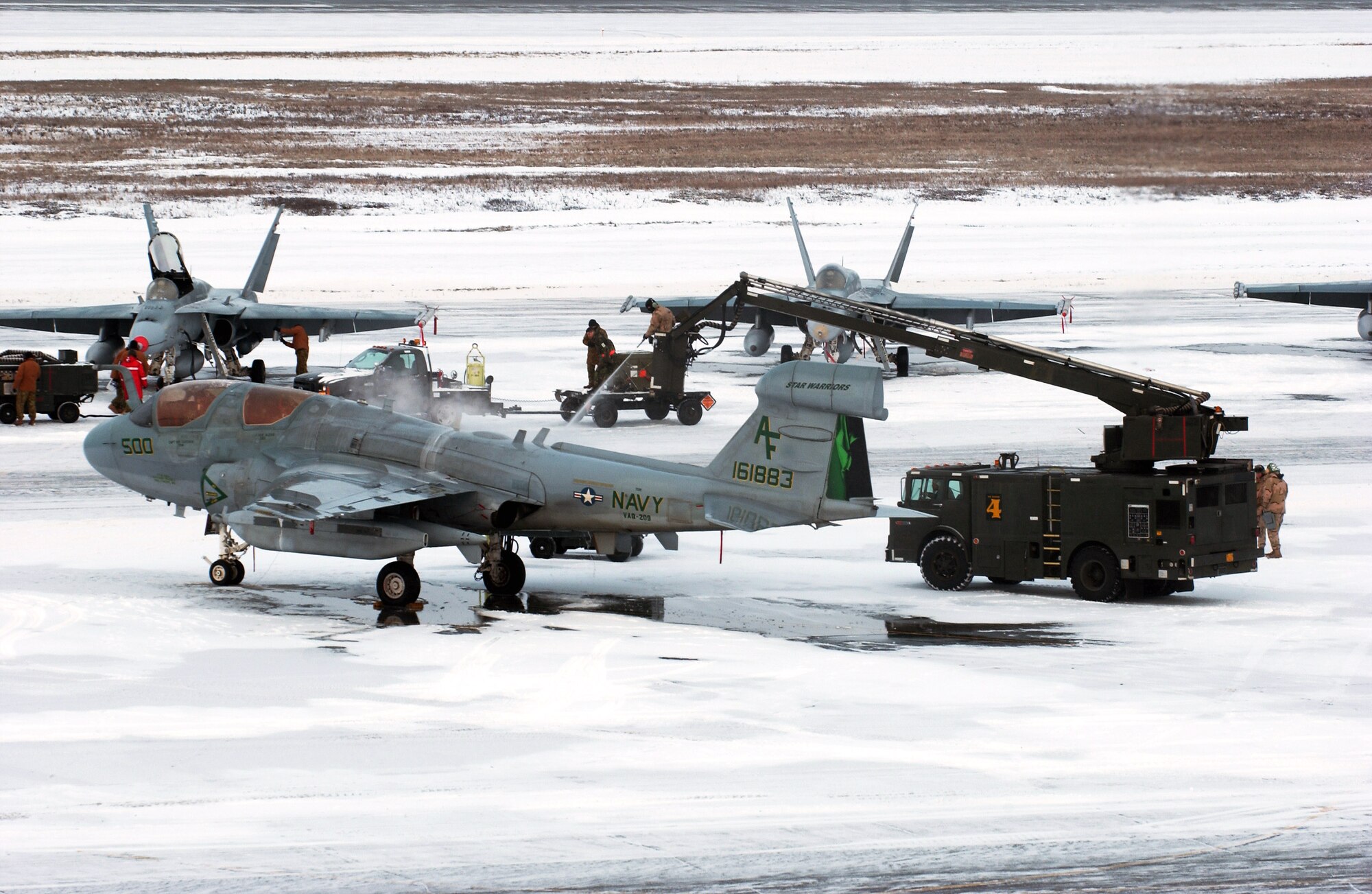 Maintainers remove snow and de-ice a Navy EA-6B Prowler for the first official day of Red Flag-Alaska 08-2 April 7 at Eielson Air Force Base, Alaska. Red Flag-Alaska provides training for deployed maintenance and support personnel in sustainment of a large-force deployed air operation. The EA-6B is assigned to the Naval Air Station Widbey Island, Wash. (U.S. Air Force photo/Airman 1st Class Jonathan Snyder) 
