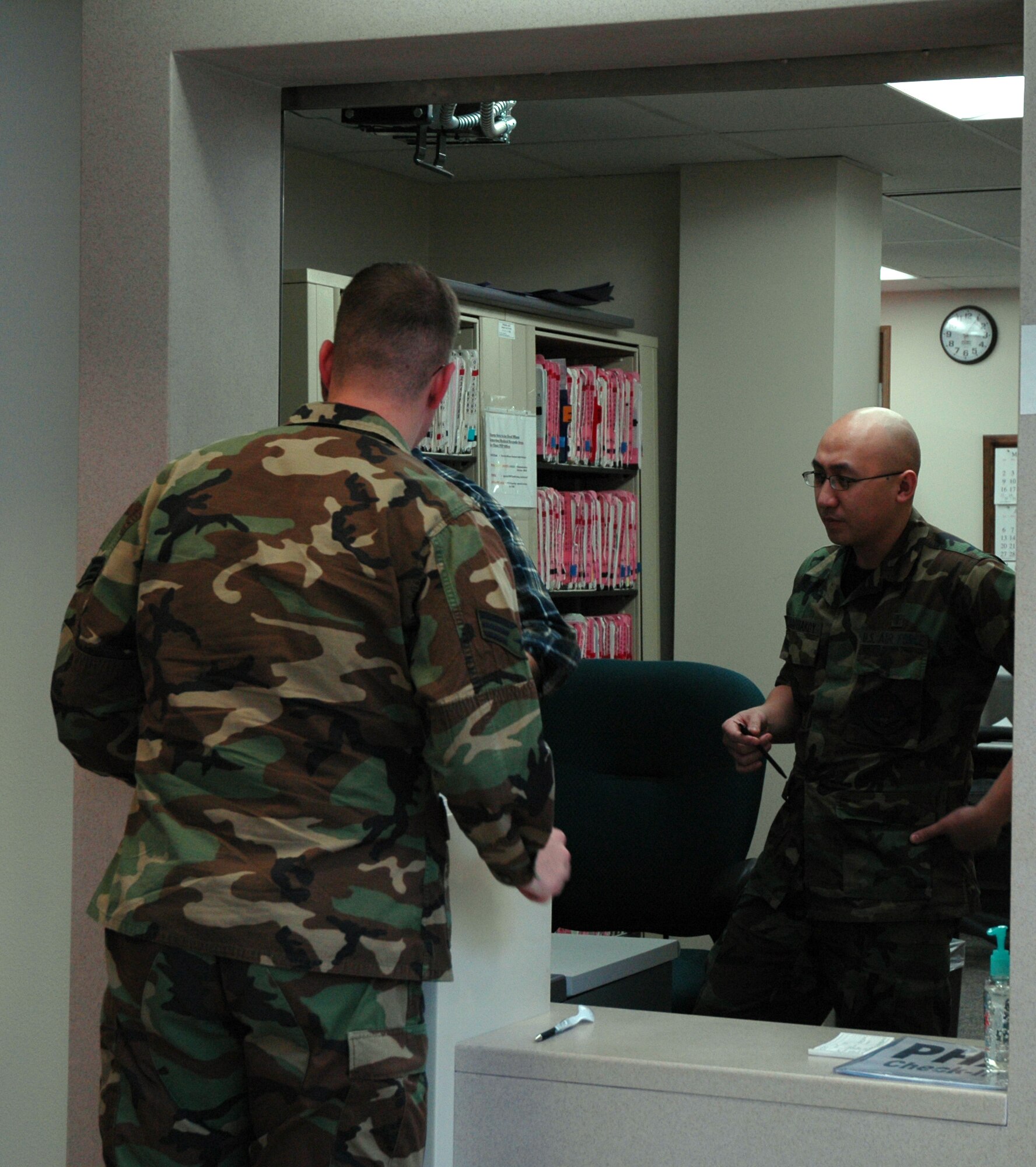 Senior Airman Kenvin Keophakdy, 341st Medical Group aerospace medical technician, assists a patient at the clinic. New American Disability Association compliant windows have been implemented in a recent phase of construction.  (U.S. Air Force photo/Airman 1st Class Emerald Ralston)
