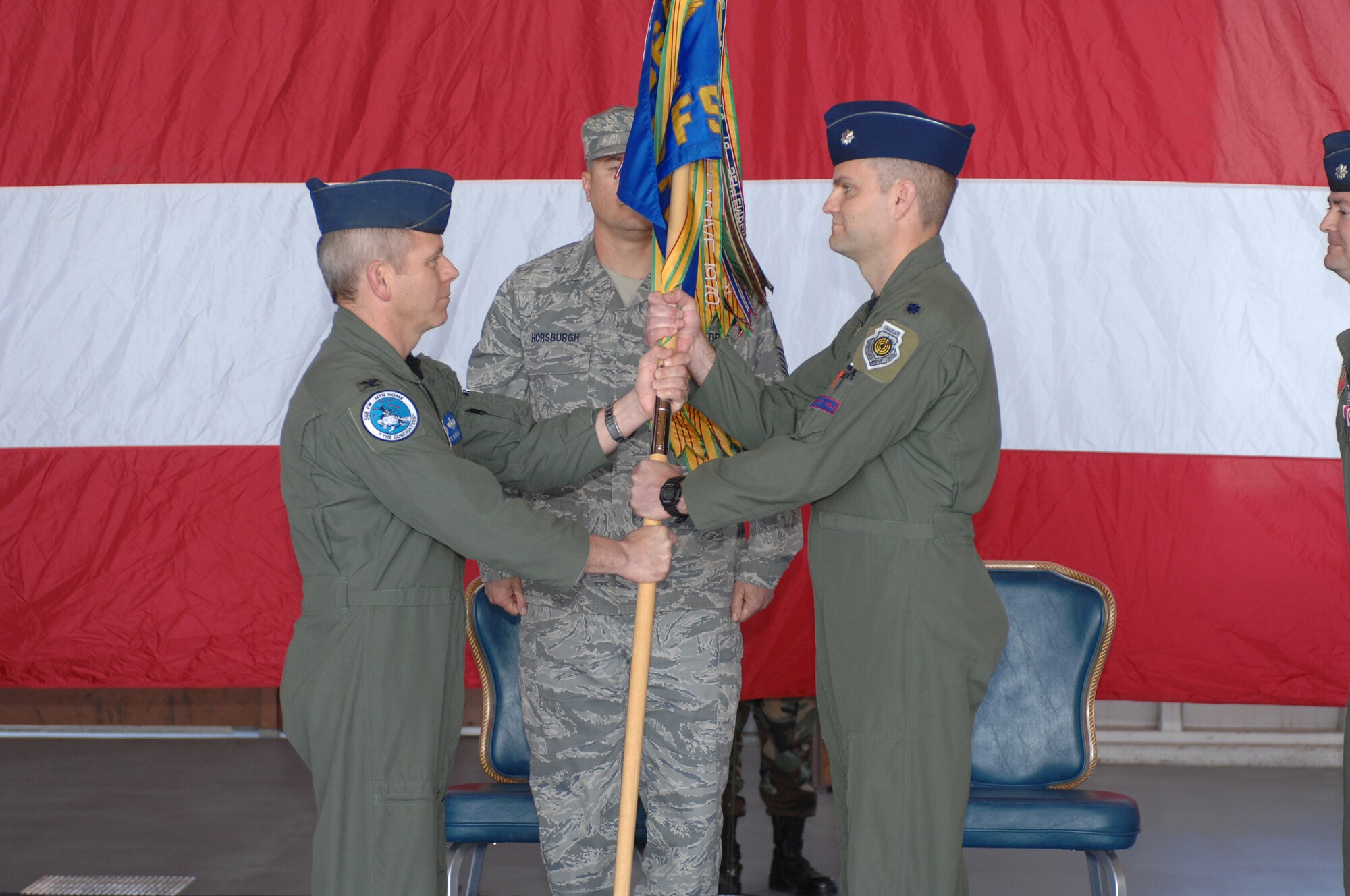 MOUNTAIN HOME AIR FORCE BASE, Idaho -- Lt. Col. Michael Koscheski (right) accepts the 389th Fighter Squadron guidon from Col. John McMullen, 366th Operations Group commander, and assumes command of the 389th FS during a change-of-command ceremony April 11 at Hangar 201. (U.S. Air Force photo/ Airman 1st Class Ryan Crane)