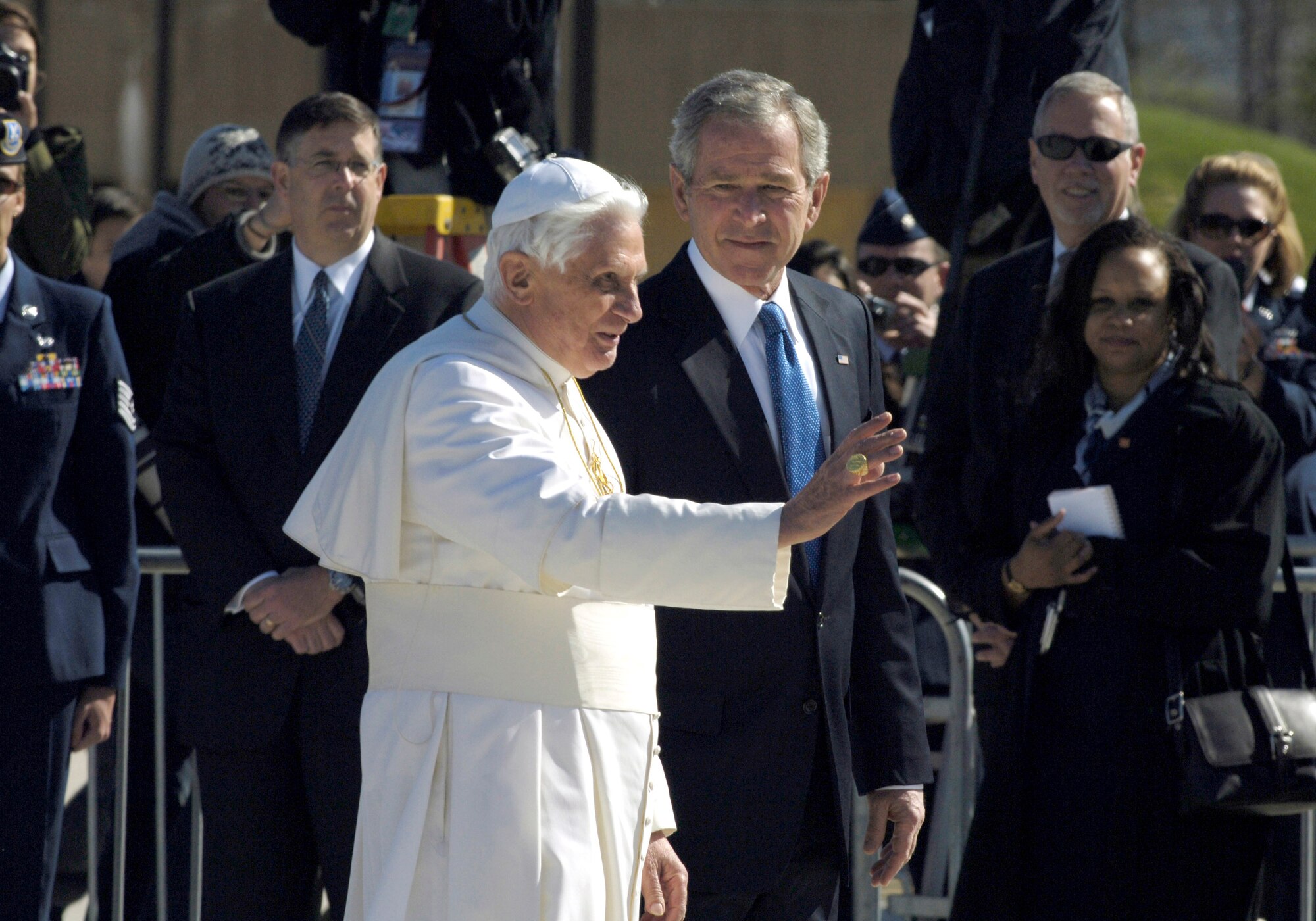 Pope Benedict XVI waves to the crowd upon his arrival as he is escorted by President George W. Bush April 15 at Andrews Air Force Base, Md. The pope is visiting the United States for a week and will meet with President Bush at the White House, address the presidents of Roman Catholic colleges and universities, and celebrate Mass at Nationals Park in Washington, D.C., and Yankee Stadium in New York City. The pontiff was selected as the 265th pope on April 19, 2005. (U.S. Air Force photo/Senior Airman Renae L. Kleckner) 
