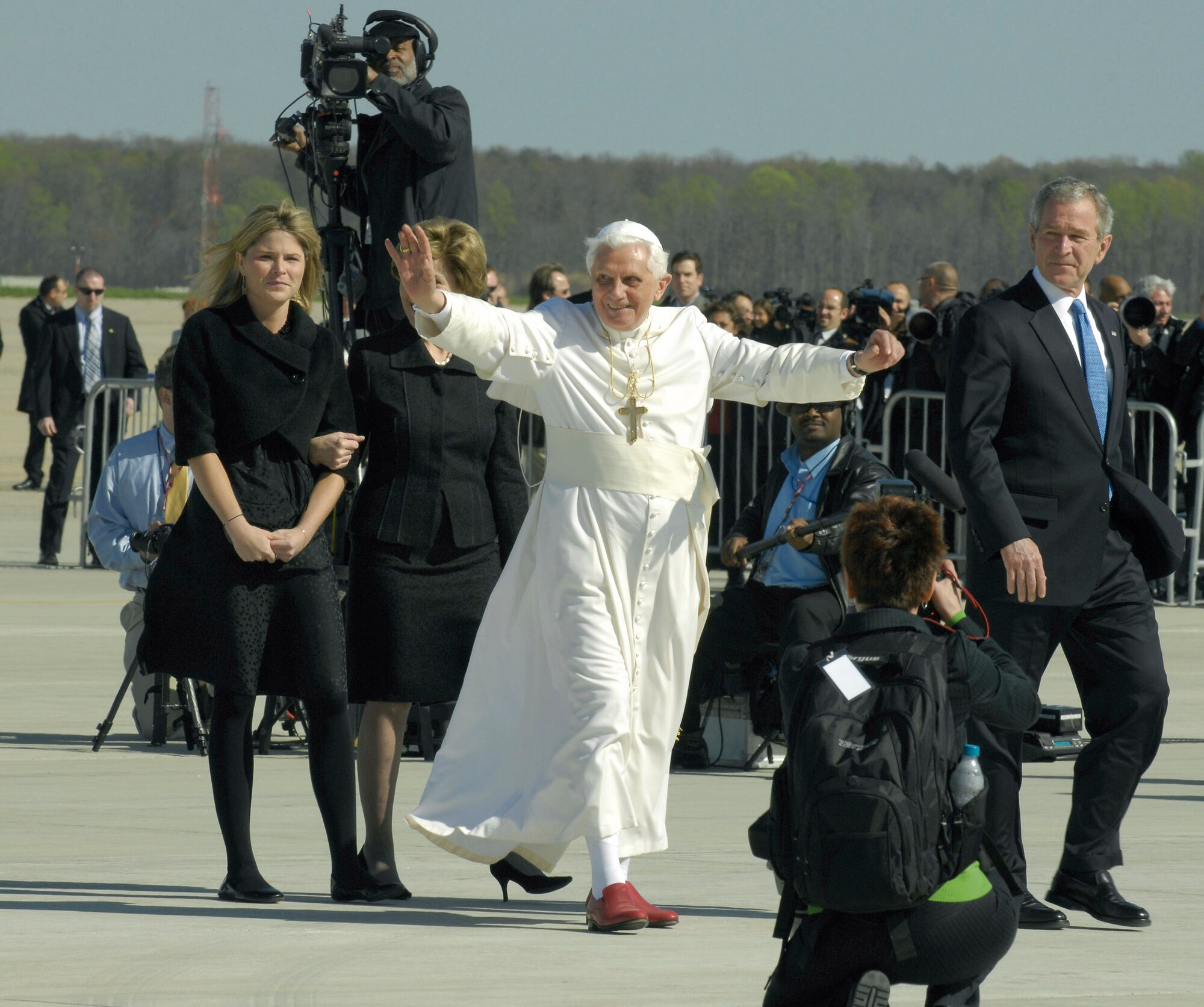 Pope Benedict XVI waves to the crowd upon his arrival as he is escorted by President George W. Bush and his family April 15 at Andrews Air Force Base, Md. The pope is visiting the United States for a week and will meet with President Bush at the White House, address the presidents of Roman Catholic colleges and universities, and celebrate Mass at Nationals Park in Washington, D.C., and Yankee Stadium in New York City. The pontiff was selected as the 265th pope on April 19, 2005. (U.S. Air Force photo/Senior Airman Renae L. Kleckner)
