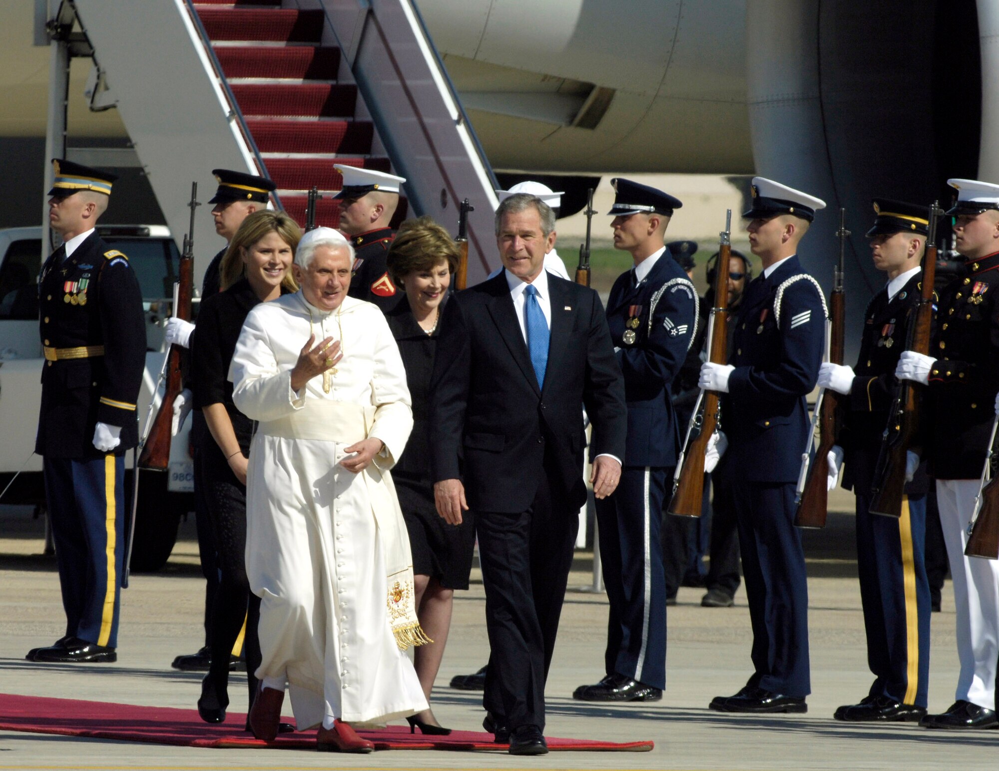 Pope Benedict XVI talks to President George W. Bush upon his arrival as he is escorted by a joint honor guard April 15 at Andrews Air Force Base, Md. The pope is visiting the United States for a week and will meet with President Bush at the White House, address the presidents of Roman Catholic colleges and universities, and celebrate Mass at Nationals Park in Washington, D.C., and Yankee Stadium in New York City. The pontiff was selected as the 265th pope on April 19, 2005. (U.S. Air Force photo/Senior Airman Renae L. Kleckner)
