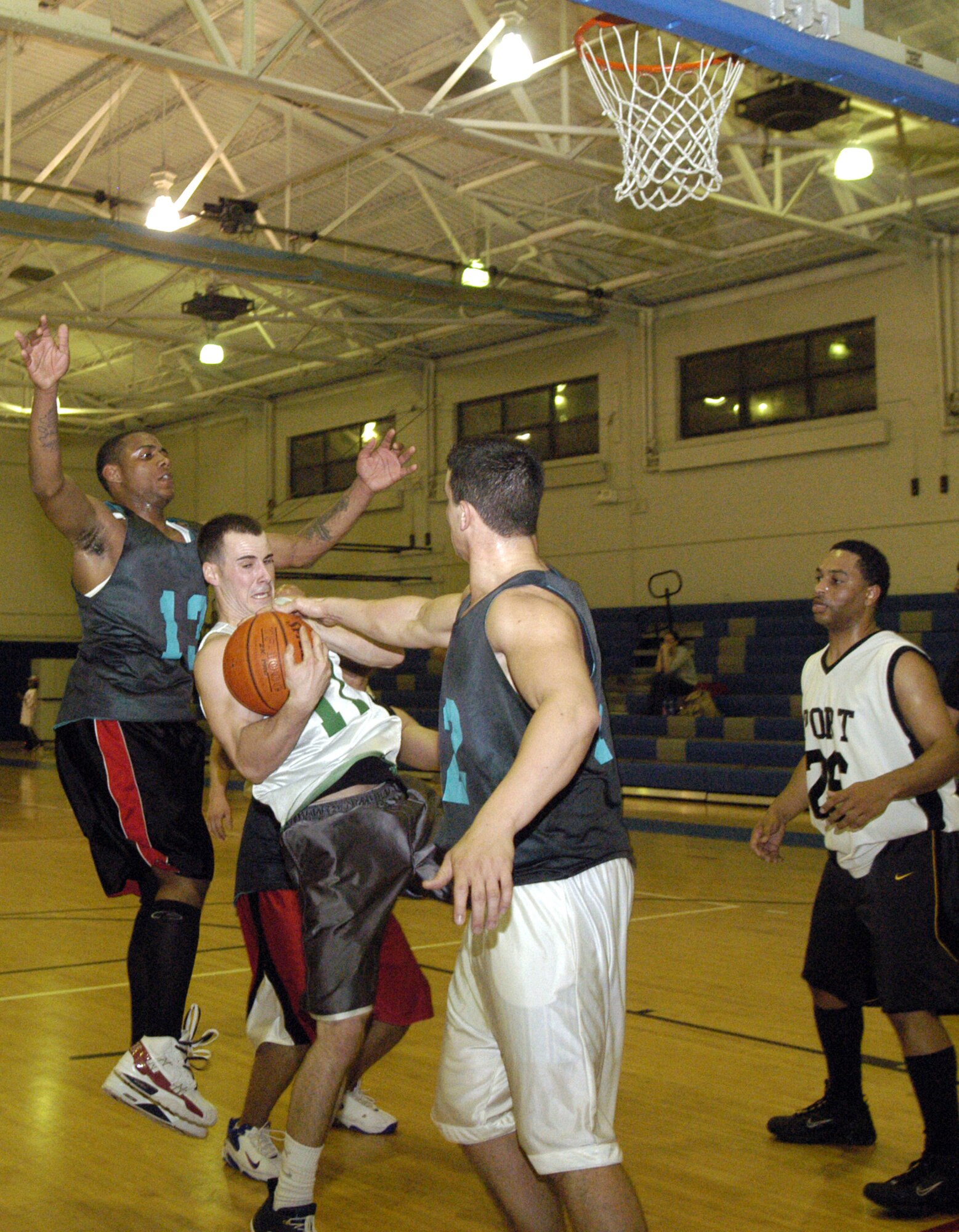 Joel Sines, 436th Operations Support Squadron, tries to grab the ball away from Nicholas Cross, 436th Aerial Port Squadron. The 436th OSS beat the 436th APS (B) 56 - 37 during an intramural basketball game April 10 at the Fitness Center. (U.S. Air Force photo/Airman 1st Class Shen-Chia Chu)