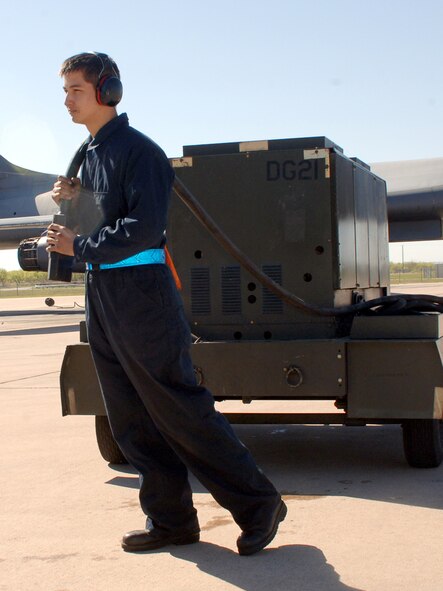 DYESS AIR FORCE BASE, Texas-- Airman 1st Class Kyle Melder, 7 Aircraft Maintenance Squadron, unrolls a generator cord for external electrical power April 15. The use the external electrical power is so that maintainers don?t have to run the systems out of the aircraft.(U.S Air Force photo by Senior Airman Felicia Juenke)