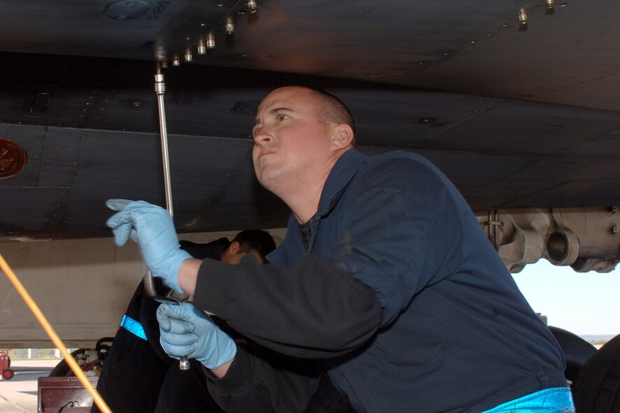 DYESS AIR FORCE BASE, Texas-- Airman 1st Class Charles Wade uses a speed handle to open a hydraulic panel in order to service the hydraulic system and to ensure the B-1 is checked thoroughly April 15. Airman 1st Class Wade is a crew chief in the 7 Aircraft Maintenance Squadron.(U.S Air Force photo by Senior Airman Felicia Juenke)