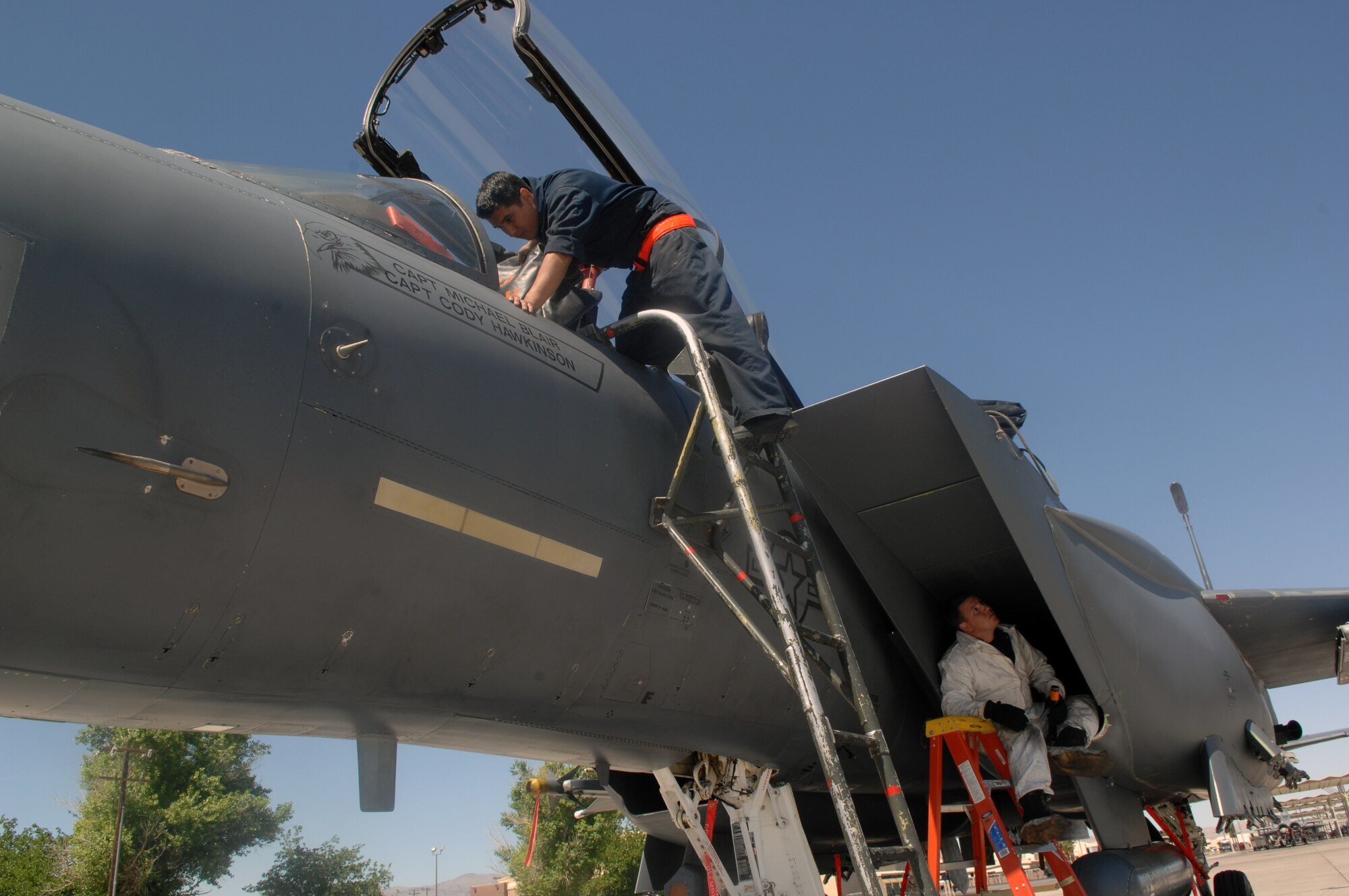 MOUNTAIN HOME AIR FORCE BASE, Idaho -- Senior Airman Marcos Flores and Staff Sgt. Charles Sparks, 391st Aircraft Maintenance Unit dedicated crew chiefs, conduct a routine post-flight inspection of an F-15E Strike Eagle after it returned from a training mission April 9 at Nellis AFB, Nev. The 391st Fighter Squadron is at Nellis until May 2 to provide support for aircrews training at the United States Air Force Weapons. The 366th Fighter Wing supports the weapons school every two years. (U.S. Air Force Photo/ Airman 1st Class Brian Ybarbo)