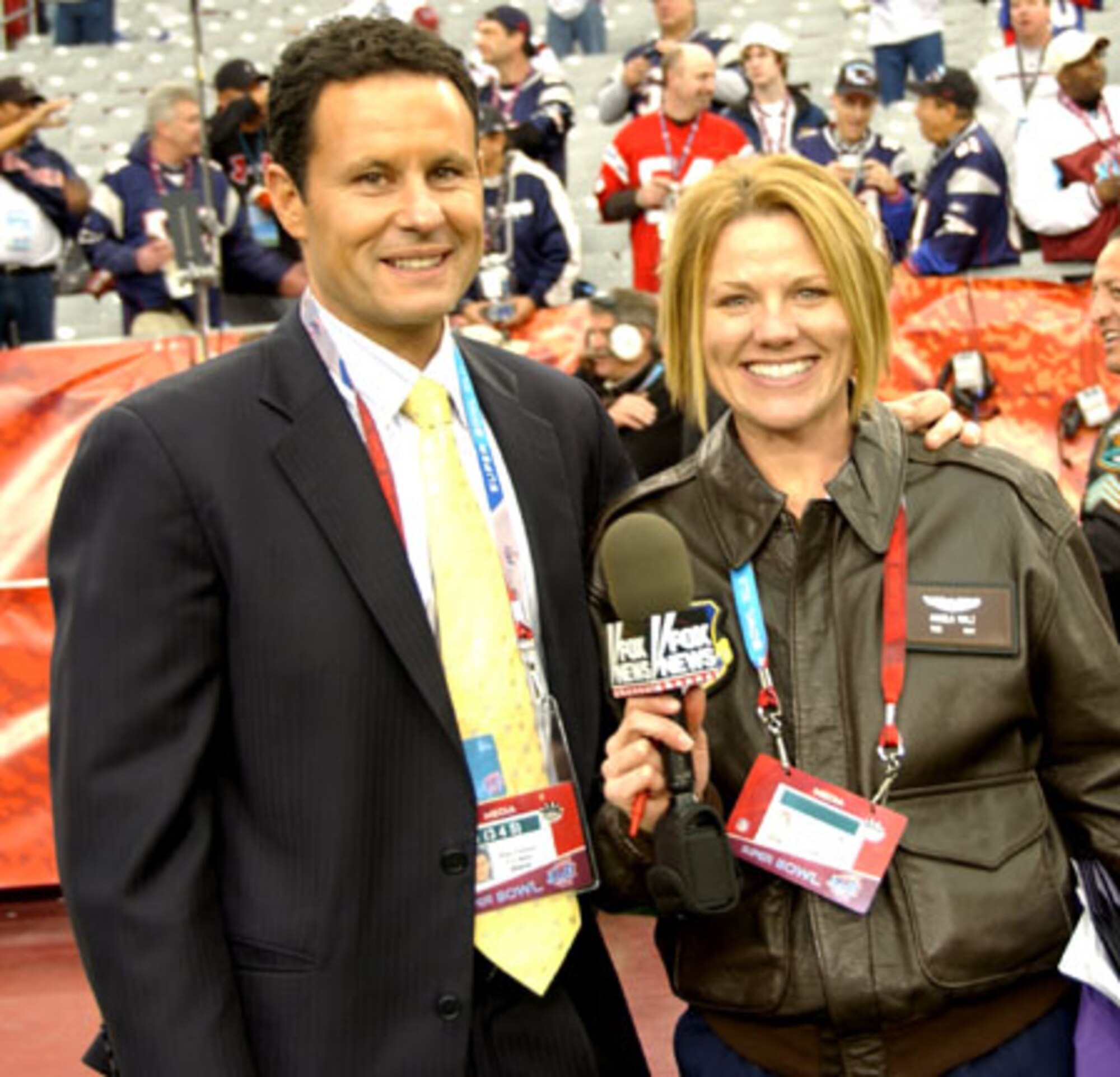 FOX News personality Brian Kilmeade stops to take a photo with fellow Super Bowl Correspondent Tech. Sgt. Angela Walz, 162nd Fighter Wing public affairs. (Air National Gaurd photo by Senior Airman Sarah Flint)