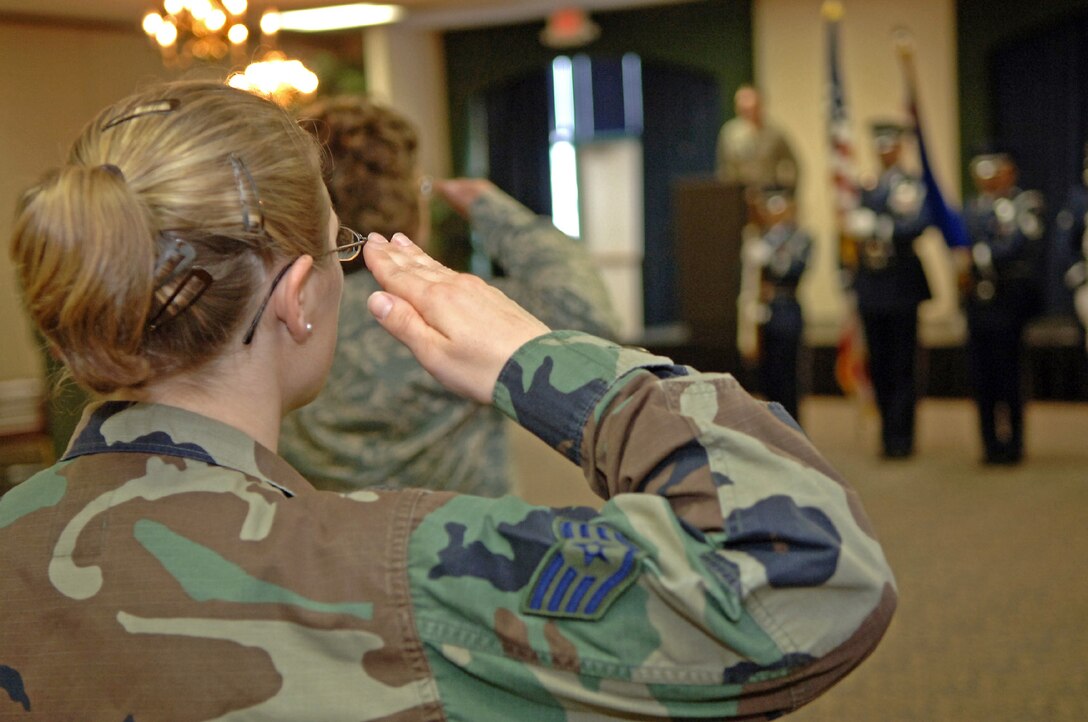 Staff Sgt. Krista Kotz, 28th Force Support Squadron Mortuary Affairs non-commissioned officer in charge, salutes during the national anthem at the FSS activation ceremony at Dakota's on April 11. The FSS was formed by combining the 28th Services Squadron and the 28th Mission Support Squadron. (U.S. Air Force photo/Senior Airman Marc I. Lane)
