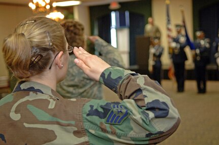 Staff Sgt. Krista Kotz, 28th Force Support Squadron Mortuary Affairs non-commissioned officer in charge, salutes during the national anthem at the FSS activation ceremony at Dakota's on April 11. The FSS was formed by combining the 28th Services Squadron and the 28th Mission Support Squadron. (U.S. Air Force photo/Senior Airman Marc I. Lane)
