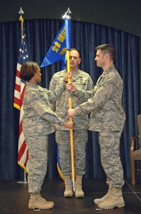 Maj. Patrick Whelan, 28 Force Support Squadron commander, assumes command by receiving the new FSS squadron guidon from Col. Renita Alexander, 28th Mission Support Group commander, at the FSS activation ceremony at DakotaÕs on April 11. The FSS represents a merger between the 28th Services Squadron and 28th Mission Support Squadron, which were deactivated prior to the FSS stand-up. (U.S. Air Force photo/Senior Airman Marc I. Lane)