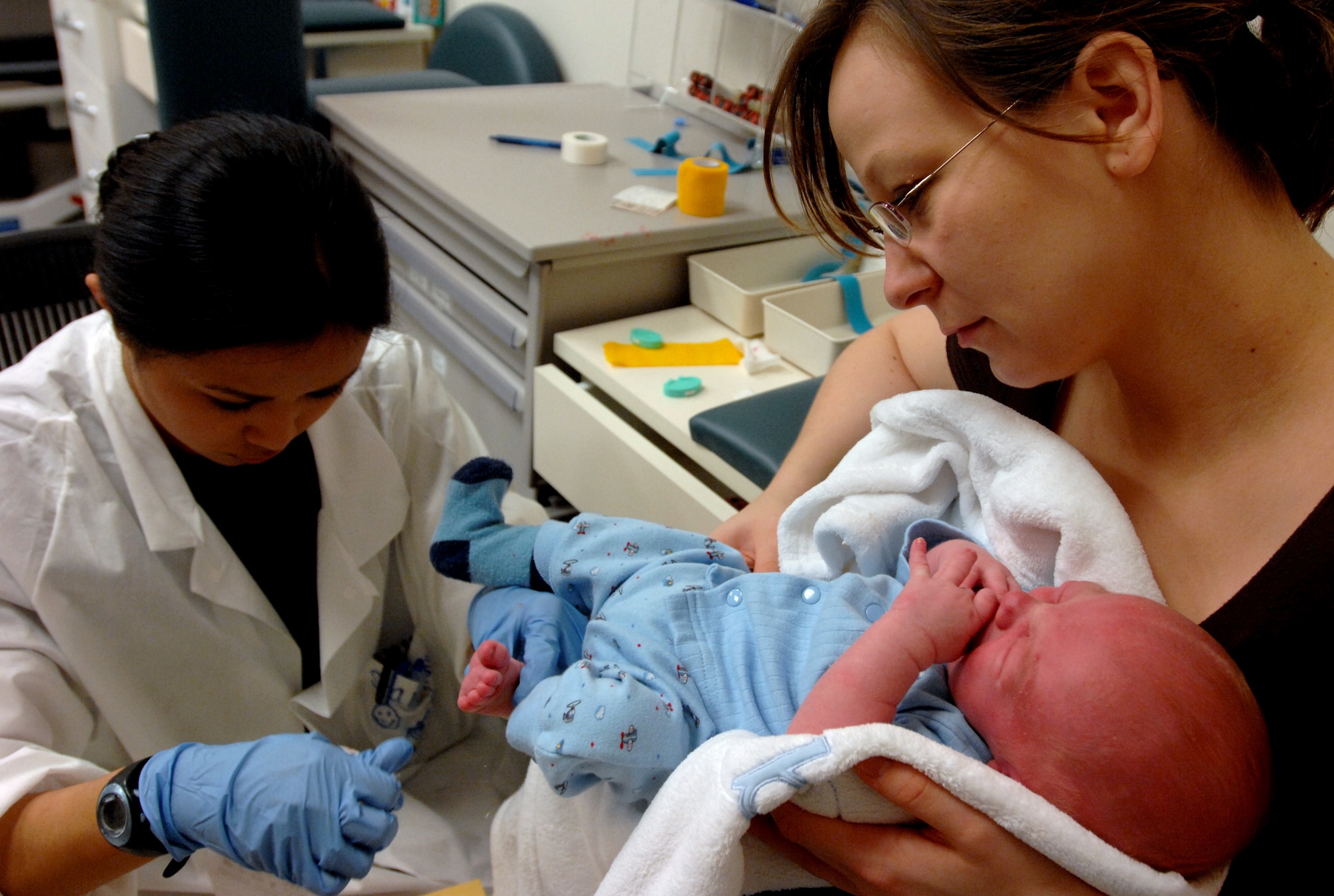 AVIANO AIR BASE, Italy --  Senior Airman Danielle Peregrino takes a blood sample from the heel of 2 week old Nicholas Laudrille, son of Ivana Laudrille, April 15.  Medical laboratory technicians take blood samples from patients to aid in diagnosing, treating and preventing diseases.  (U.S. Air Force photo/Airman 1st Class Tabitha M. Mans)