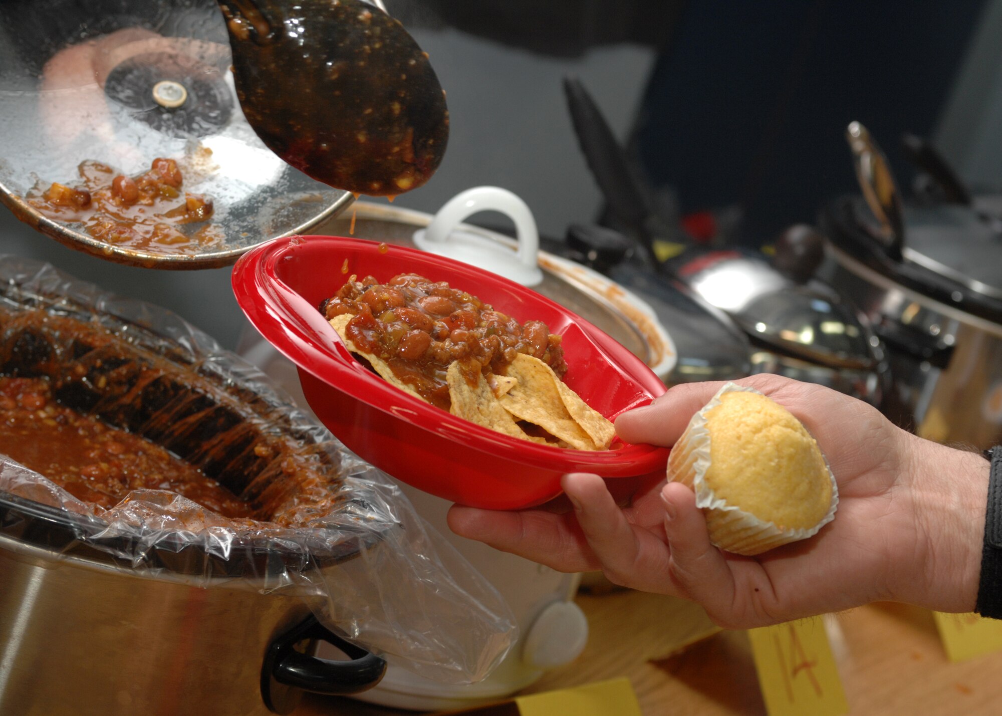 SPANGDAHLEM AIR BASE, Germany -- Chili is poured in to a bowl at the Spangdahlem Middle School’s Odyssey of the Mind dinner theater and chili cook-off fundraiser April 15, 2008. The chili cook-off was sponsored by the Spangdahlem Middle School in hopes to offset some of the costs associated with sending the Odyssey of the Mind teams to the world competition later in May in Maryland. Approximately $700 was raised in presale tickets alone. (Air Force photo/Airman 1st Class Jenifer Calhoun)