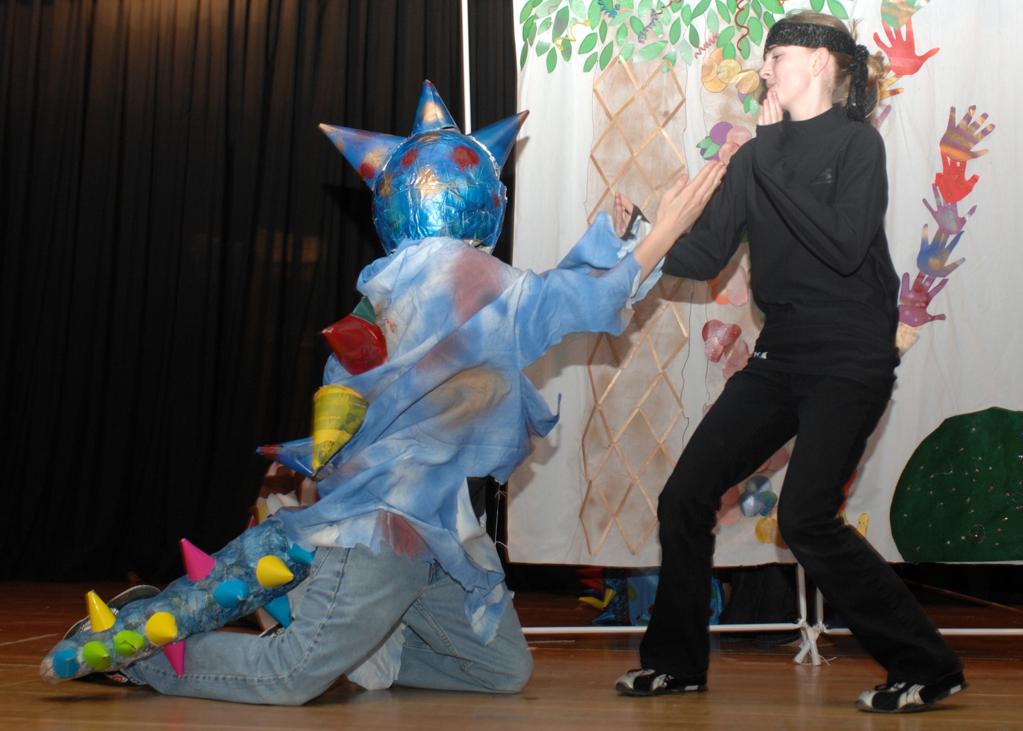 SPANGDAHLEM AIR BASE, Germany -- Ninja, Elizabeth Buchholz, shows exactly how the dinosaurs became extinct against dinosaur, Paul Naisbitt, during their performance at the Spangdahlem Middle School’s Odyssey of the Mind dinner theater and chili cook-off fundraiser April 15, 2008. Elizabeth and Paul are members of one of the four teams from Spangdahlem going to the world competition to be held in Maryland later in May. (Air Force photo/Airman 1st Class Jenifer Calhoun)