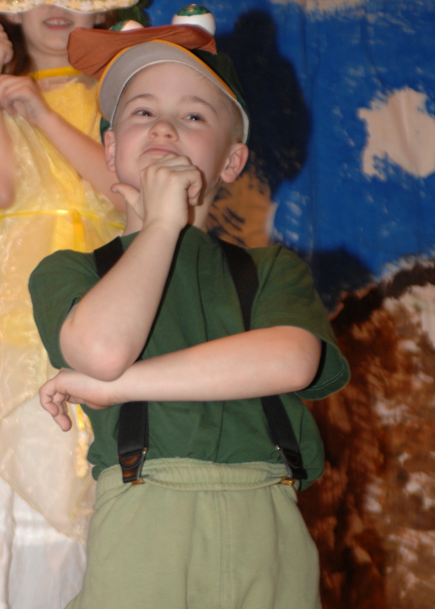 SPANGDAHLEM AIR BASE, Germany -- Michael Perleberg, Spangdahlem Elementary School Division I team, contemplates how the dinosaurs became extinct at the Spangdahlem Middle School’s Odyssey of the Mind dinner theater and chili cook-off fundraiser April 15, 2008. Michael and the rest of the team placed 2nd at the European competition March 31, 2008, and are on their way to the world competition to be held sometime in May in Maryland. (Air Force photo/Airman 1st Class Jenifer Calhoun)