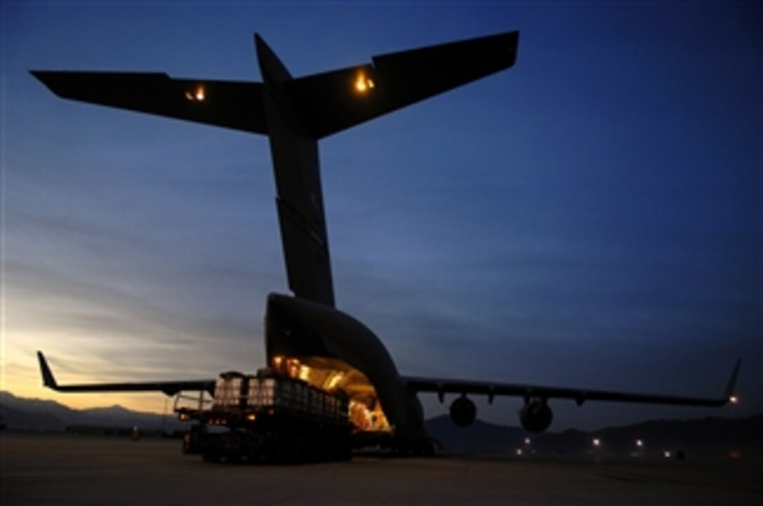 U.S. Air Force Airmen and Army soldiers load 40 bundles of humanitarian supplies into a C-17 Globemaster III aircraft at Bagram Air Base, Afghanistan, on April 13, 2008.  Using a joint precision airdrop delivery system the supplies will be dropped over Afghanistan.  
