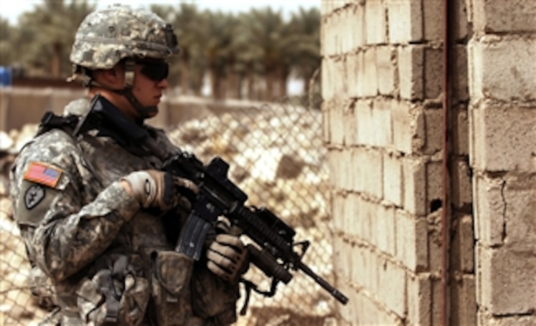 U.S. Army Spc. Timothy Lewis provides security as provincial reconstruction team members inspect a water access point near Al Raoud, Iraq, April 10, 2008. Lewis is assigned to 25th Infantry Division's Charlie Company, 1st Battalion, 27th Infantry Regiment, Stryker Brigade Combat Team. 