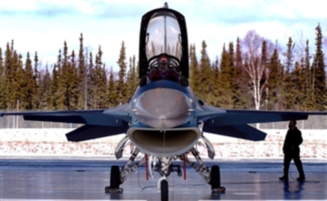 U.S. Air Force Capt. Chris Lehto checks the responsiveness of the flap controls on an F-16 Aggressor aircraft while Airman 1st Class Clint Gessler looks for anything unusual, Eielson Air Force Base, Alaska, April 11, 2008. Gessler is a crew chief assigned to the 354th Aircraft Maintenance Squadron. 