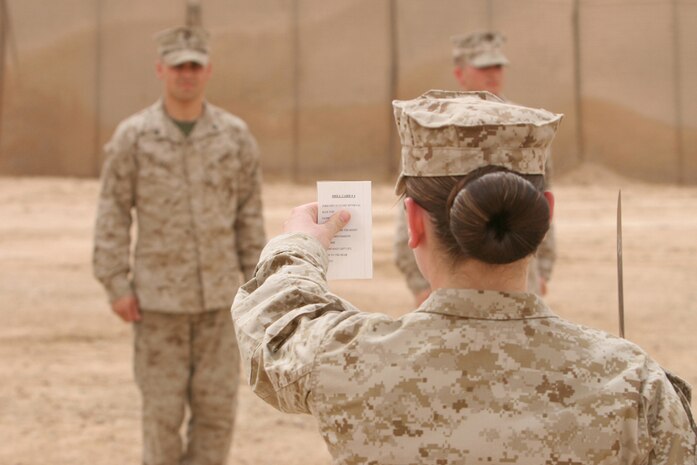 Cpl. Chantel Saville,20, logistics clerk, Headquarters Company, Regimental Combat Team 5, reviews her drill card during the drill portion of RCT-5â??s corporals course at Camp Ripper, Iraq, April 16.  Nineteen corporals from Headquarters Co. participated in the 10-day course that taught the corporals a variety of leadership skills, including close-order drill, combat stress management and leadership styles.