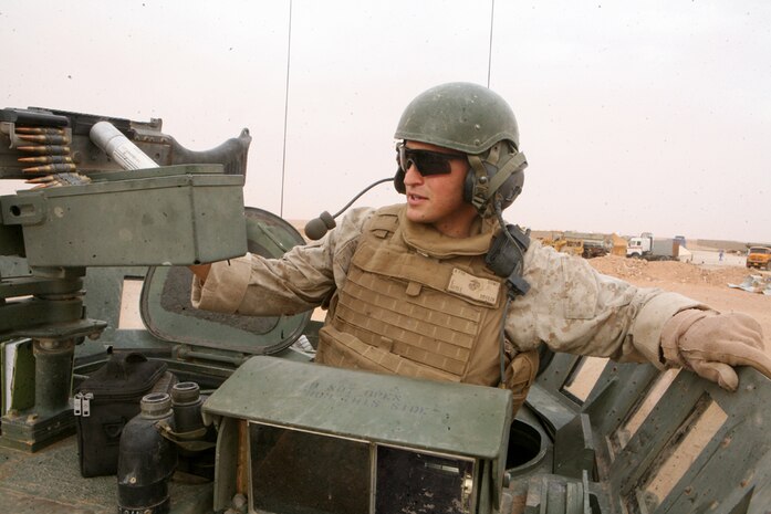 Pfc. Ettai Doyle, 19, a scout with Task Force Mustang, 2nd Light Armored Reconnaissance Battalion, Regimental Combat Team 5, watches for any suspicious vehicles or persons while providing security for construction workers as they build a new Iraqi Army compound in western Anbar province, Iraq, April 16. The Marines have been conducting these operations since arriving in the western Anbar province and won't be relieved until the compound is complete and Light Infantry Battalion, 4th Iraqi Army Brigade, 7th Iraqi Army Division, moves in.