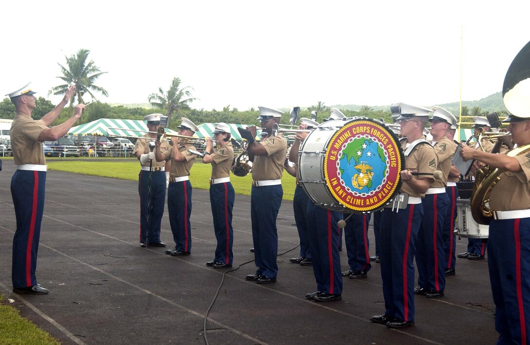 Warrent Officer Bryan Sherlock conducts the U.S. Marine Corps Forces, Pacific band during their performance for the opening ceremonies of the 108th Flag Day two-celebration commemorating the first American Flag raising over American Samoa, April 17.
