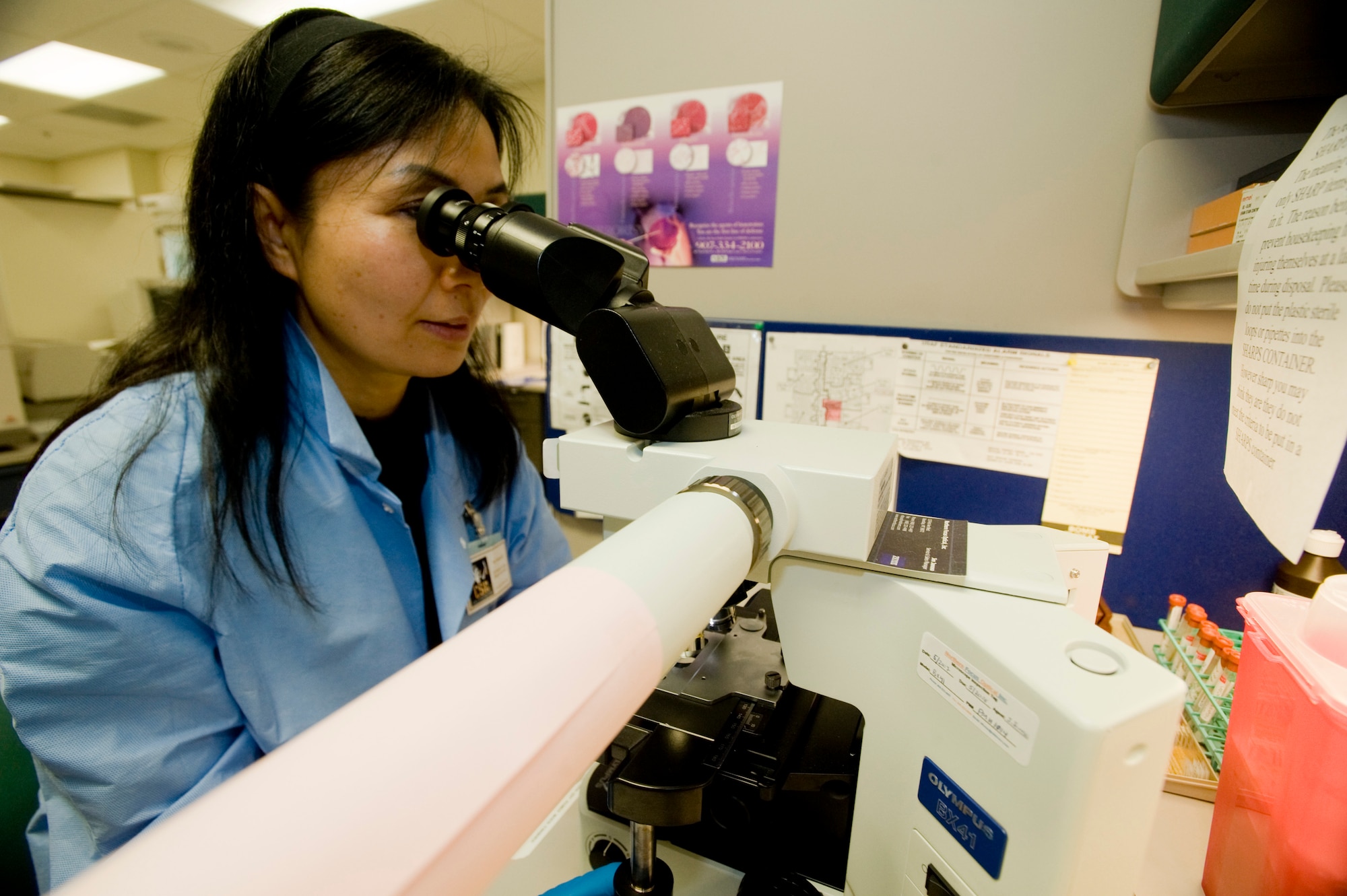 Hui Diamond, 3rd Medical Support Squadron, examines a wet prep through a microscope. This test checks samples for any unusual cell or organisms. (U.S. Air Force photo by Airman 1st Class Jonathan Steffen) 

