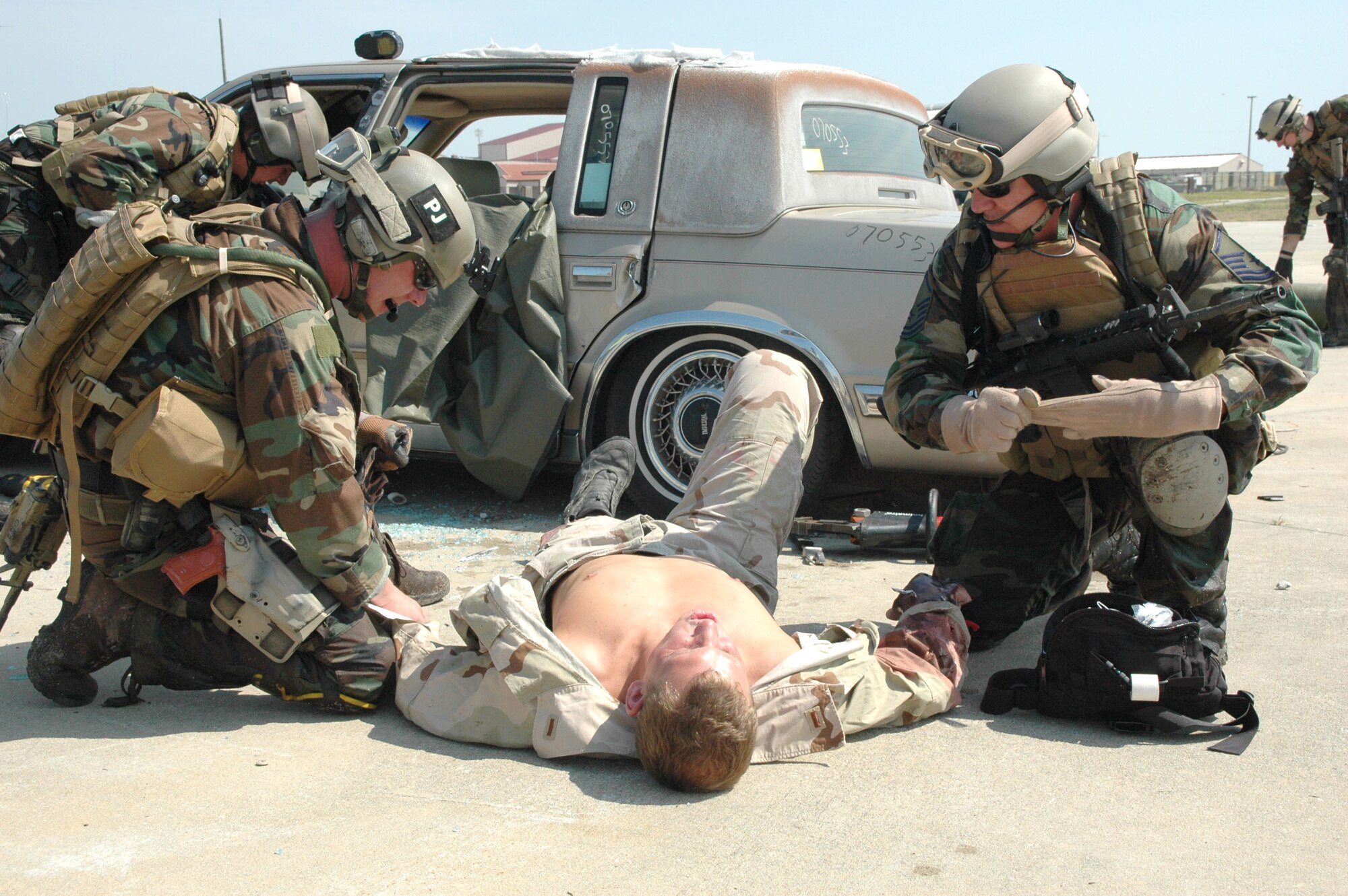 PATRICK AIR FORCE BASE, Fla. - Air Force Reserve pararescuemen (PJs), from the 920th Rescue Wing, Patrick Air Force Base, Fla., are trained to save lives - anytime, anywhere.  In a ground training exercise they hone their skills in combat car extraction and medical treatment.  In the scenario, a four-man PJ team is on alert in Afghanistan when an improvised explosive device leaves two carful of people trapped and injured.  Within minutes the PJs are on the scene.  After a brief assessment they offer assistance in the order of need based on injures and continue to treat, stabilize and package patients onto liters for evacuation.  Reservists like these PJs, serve on the frontlines and on the leading edge of technology providing the Air Force a warfighting capability that is the best in the world. (U.S. Air Force Photo/Kristin Mack)  