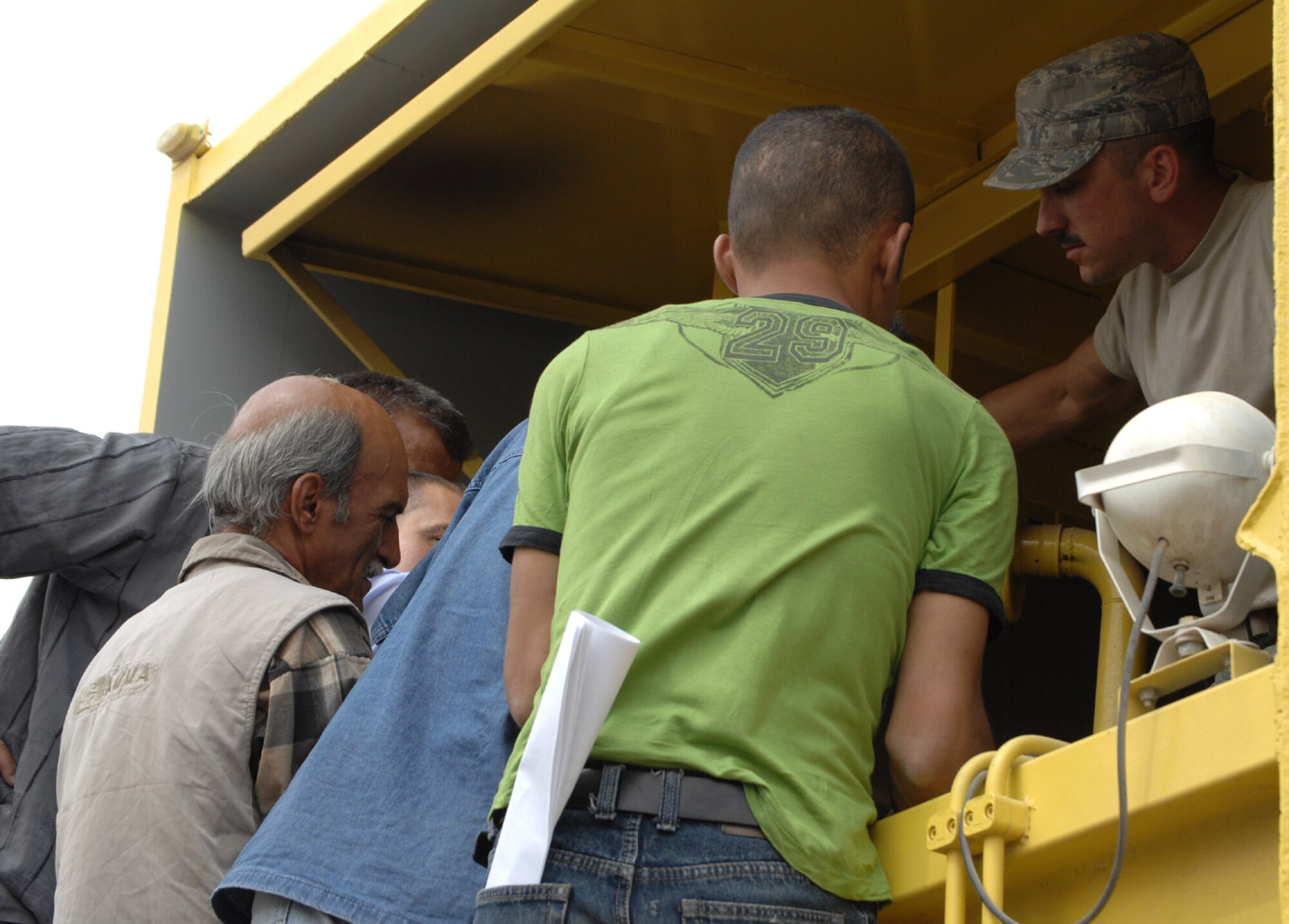 Staff Sgt. Shawn Reed, 506th Expeditionary Logistics Readiness Squadron vehicle mechanic, trains several local mechanics on preventative maintenance techniques April 16 here. The 506th ELRS Vehicle Management Flight teamed with Kirkuk's Provicinal Reconstruction Team to train 11 Iraqis on proper maintenance techniques for newly acquired equipment the Municipality of Kirkuk will use for waste management. (U.S. Air Force photo by Senior Airmen SerMae Lampkin)