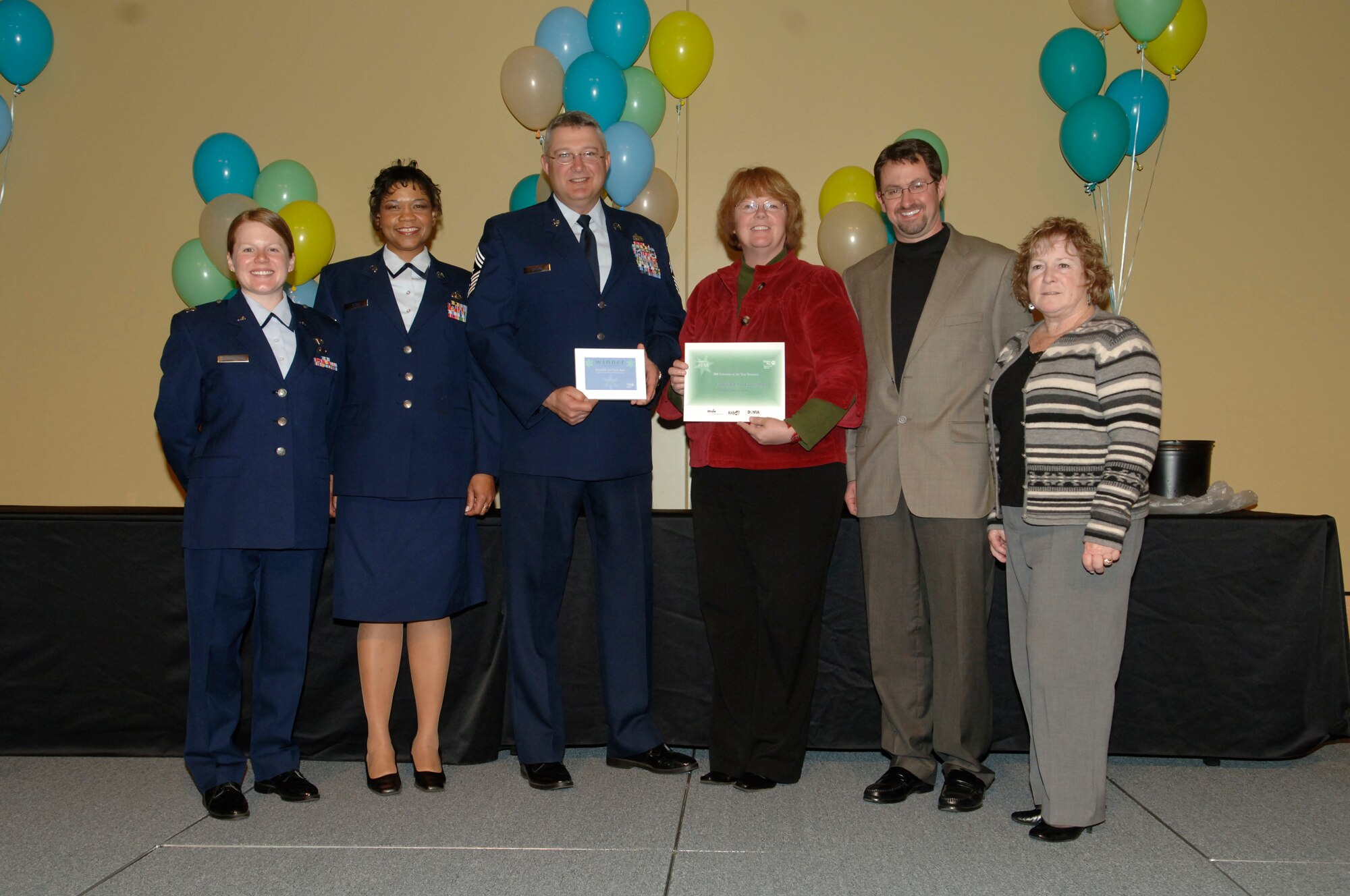 FAIRCHILD AIR FORCE BASE, Wash. – Fairchild Air Force Base won the Business Category Volunteer of the Year Award from the Spokane County United Way on April 16, at the Spokane Convention Center. Pictured accepting the award, from left, Capt. Jennifer Schoffstall, 509th Weapons Squadron, Tech. Sgt. Melva Stith, 509th Weapons Squadron, Chief Master Sgt. Paul Sikora, 92nd Air Refueling Wing command chief, Julie Nesbitt, 2nd Harvest Inland Northwest volunteer program manager, Rod Wieber, 2nd Harvest Inland Northwest director of donor and community relations, and Peggy Gallinger, 2nd Harvest Inland Northwest director of development. (U.S. Air Force photo/Senior Airman Chad Watkins)