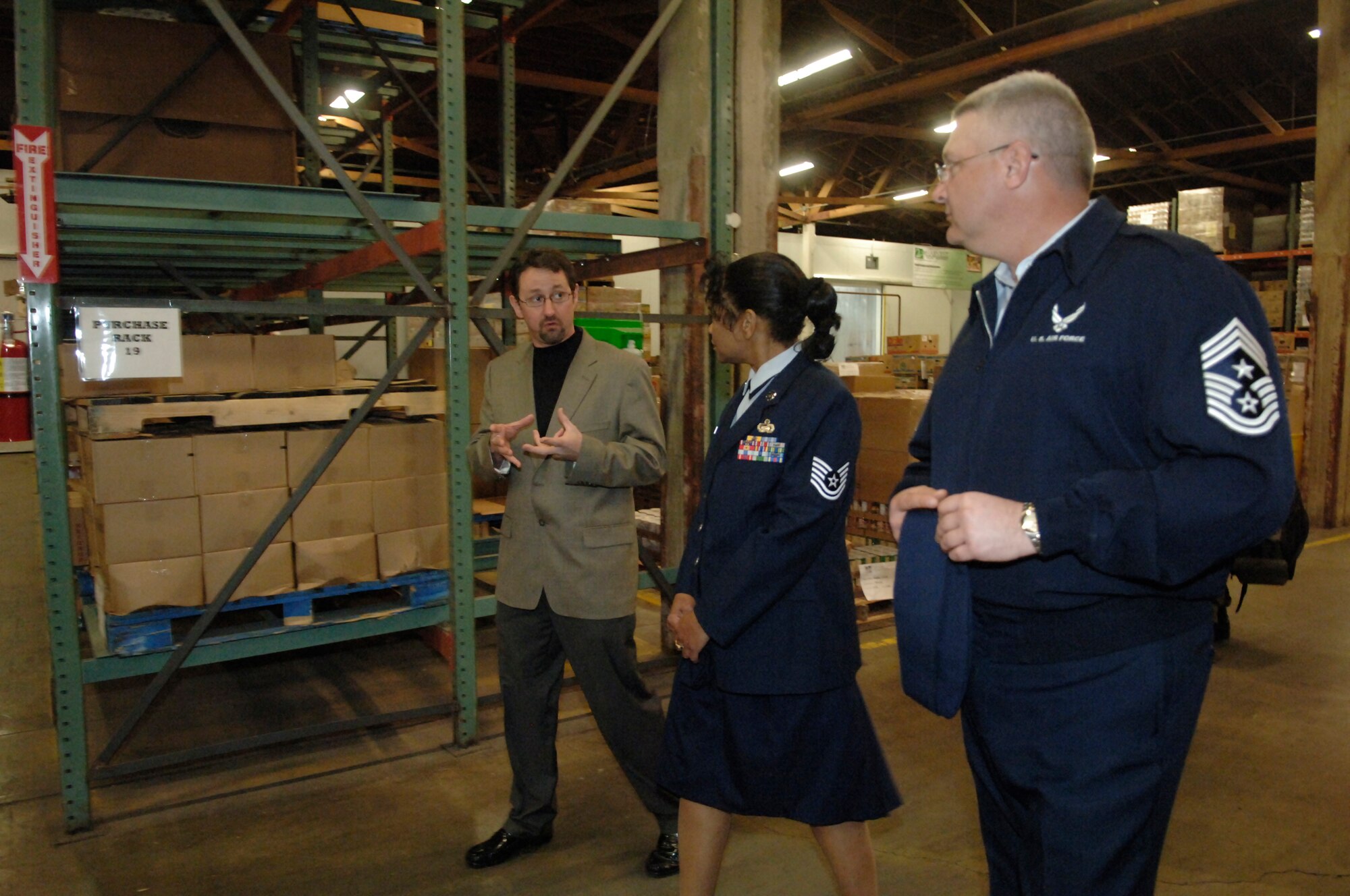 FAIRCHILD AIR FORCE BASE, Wash. – Rod Wieber, 2nd Harvest Inland Northwest director of donor and community relations, gives a tour of the 2nd Harvest Inland Northwest facility to Tech. Sgt. Melva Stith, 509th Weapons Squadron, and Chief Master Sgt. Paul Sikora, 92nd Air Refueling Wing command chief. (U.S. Air Force photo/Senior Airman Chad Watkins)  