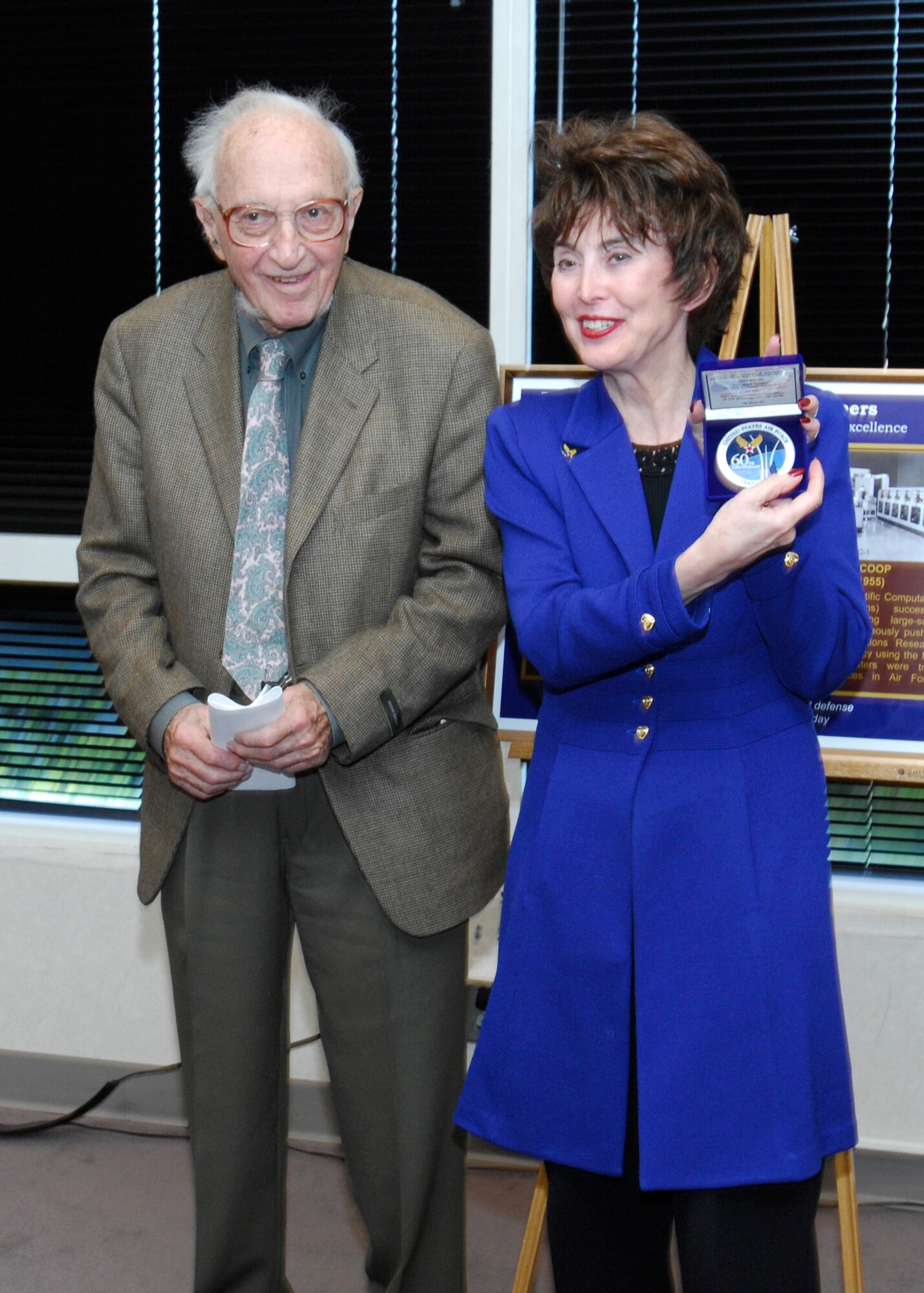 Dr. Jacqueline R. Henningsen, director for Air Force Studies and Analyses, Assessments and Lessons Learned, presents Dr. Alex Orden with a 60th Air Force anniversary medallion Sept. 18, 2007. (U.S. Air Force photo/Michael Pausic)
