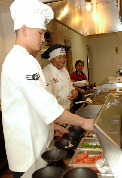 FAIRCHILD AIR FORCE BASE, Wash. – Airman 1st Class Johann Ko, 92nd Services Squadron first cook, and Airman Tamekia Jackson, 92nd SVS chef, prepare omelets at the Warrior Dining Facility here April 17. The services squadron was awarded the Air Mobility Command Maj. Gen. Eugene L. Eubank Award, and was visited by the Eubank Team, which evaluates services provided to the base, to compete for the award at Air Force level. The Eubank team visited Fairchild to evaluate. (U.S. Air Force photo/Airman 1st Class Darlene West)