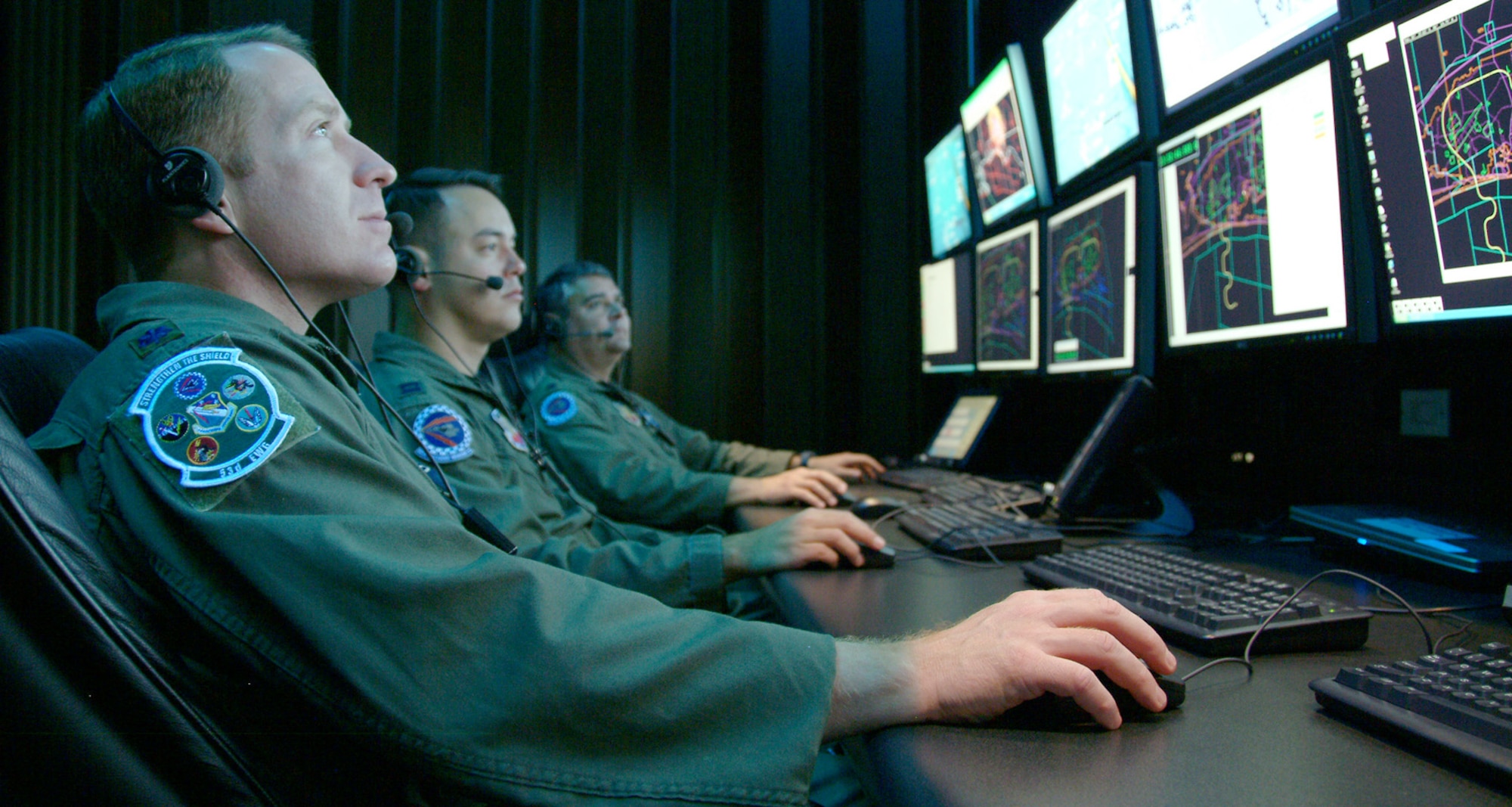Lt. Col. Tim Sands (from left), Capt. Jon Smith and Lt. Col. John Arnold monitor a simulated test April 16 in the Central Control Facility at Eglin Air Force Base, Fla. They use the Central Control Facility to oversee electronic warfare mission data flight testing. Portions of their missions may expand under the new Air Force Cyber Command. Colonel Sands is the 53th Electronic Warfare Group AFCYBER Transition Team Chief, Captain Smith is the 36th Electronic Warfare Squadron Suppression of Enemy Air Defensestest director, and Colonel Arnold is the 36th Electronic Warfare Squadron commander. (U.S. Air Force photo/Capt. Carrie Kessler)
