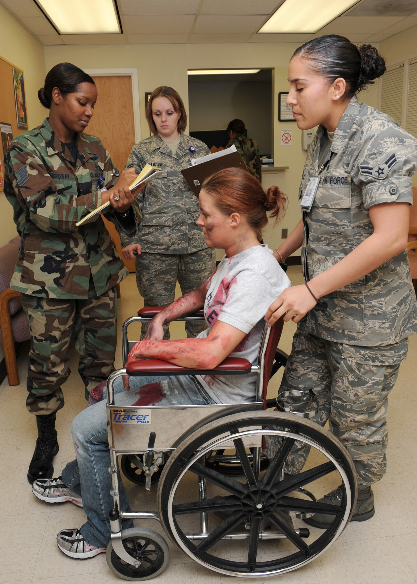 Technical Sergeant Latasha Carroway, 4th Medical Group, checks in an injured patient during the Mass Accident Response Exercise (MARE), while two other Airmen assist her at Seymour Johnson AFB, North Carolina on April 9, 2008.  The 4th Medical Group is required to perform MARE annually.     

(US Air Force photo by Airman First Class Salma Din)(Released)

