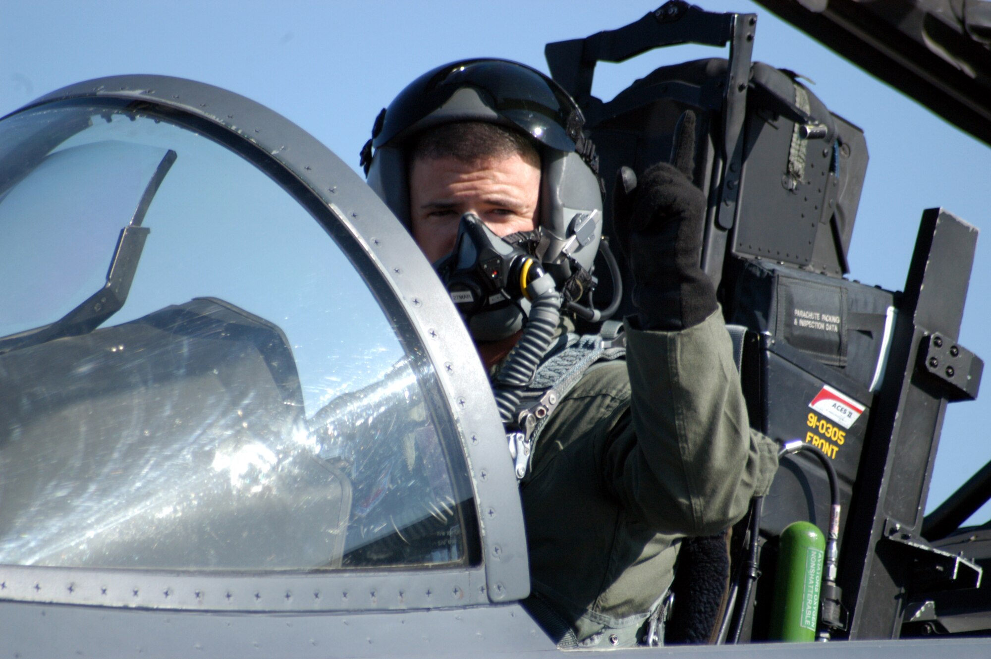 SANTIAGO, Chile -- Capt. Phil Smith signals to his crew chief that he's firing up engine No. 1 on his F-15E Strike Eagle April 1.  Captain Smith is the pilot for the F-15E Strike Eagle Demonstration Team and performed a number of times for FIDAE 2008. (U.S. Air Force photo/Master Sgt. Jason Tudor)