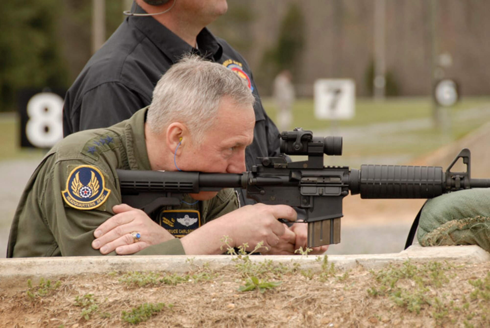 General Carlson shoots an M-4 carbine at the bases 50-300 meter combat range. (Photo by Rick Goodfriend) 